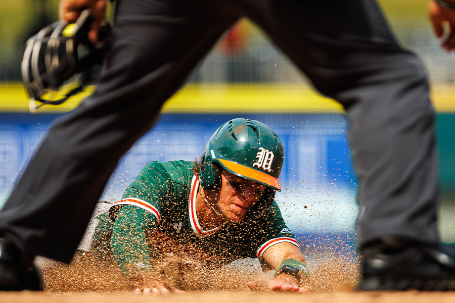 A Miami Hurricanes baseball player slides into home plate during their game against the Stanford Cardinals during the ACC Baseball Championship at Truist Field on May 20, 2026. Miami won 11-2.  (Photo by Miles Lineberger / The ACC)
