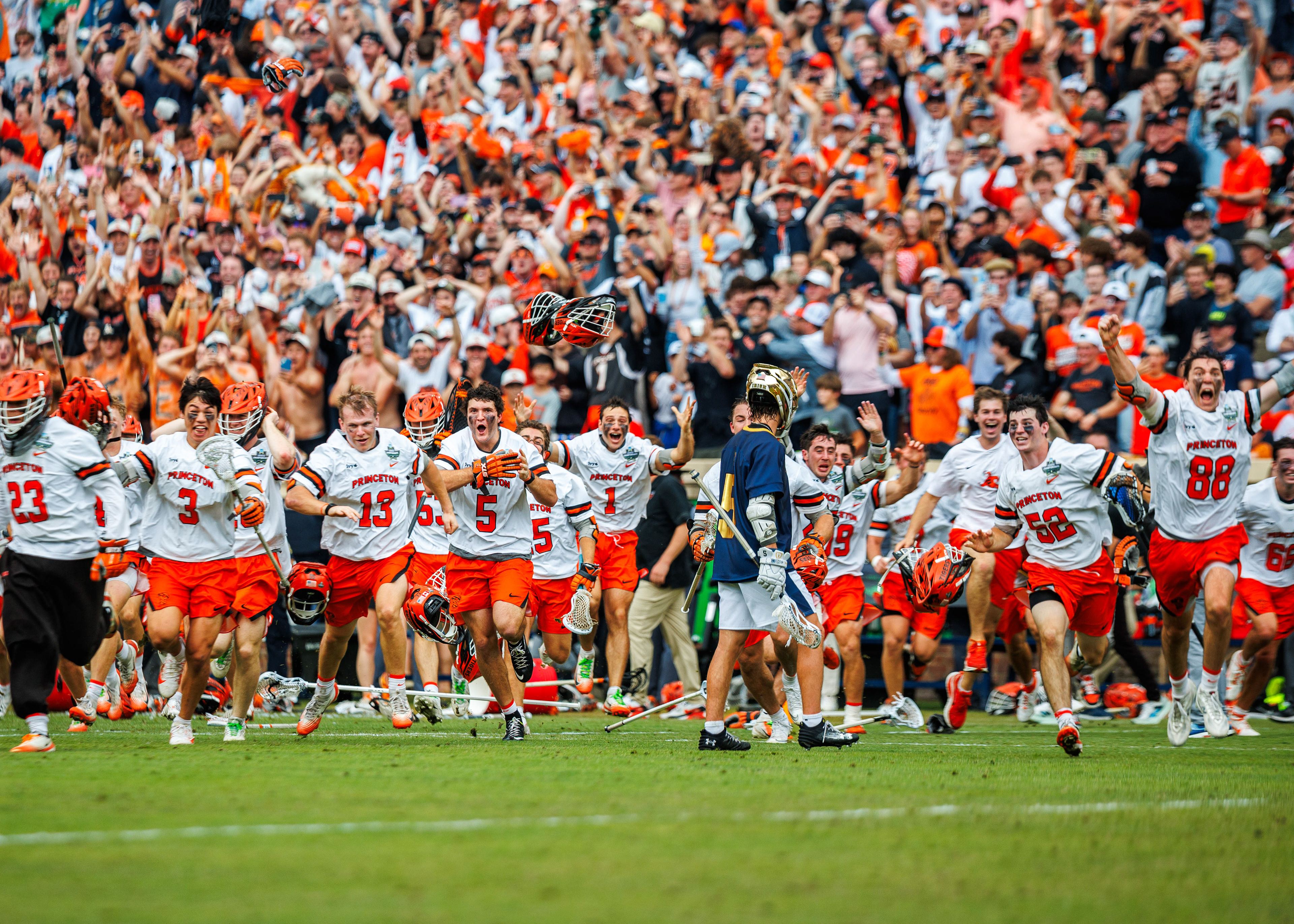 Notre Dame Fighting Irish attack Teddy Lally (5) looks on as Princeton Tigers players run onto the field in celebration after Princeton's 16-9 win in the 2026 NCAA Division I Men's Lacrosse Championship at Scott Stadium on May 25, 2026.  (Photo by Miles Lineberger / First Class Lacrosse)