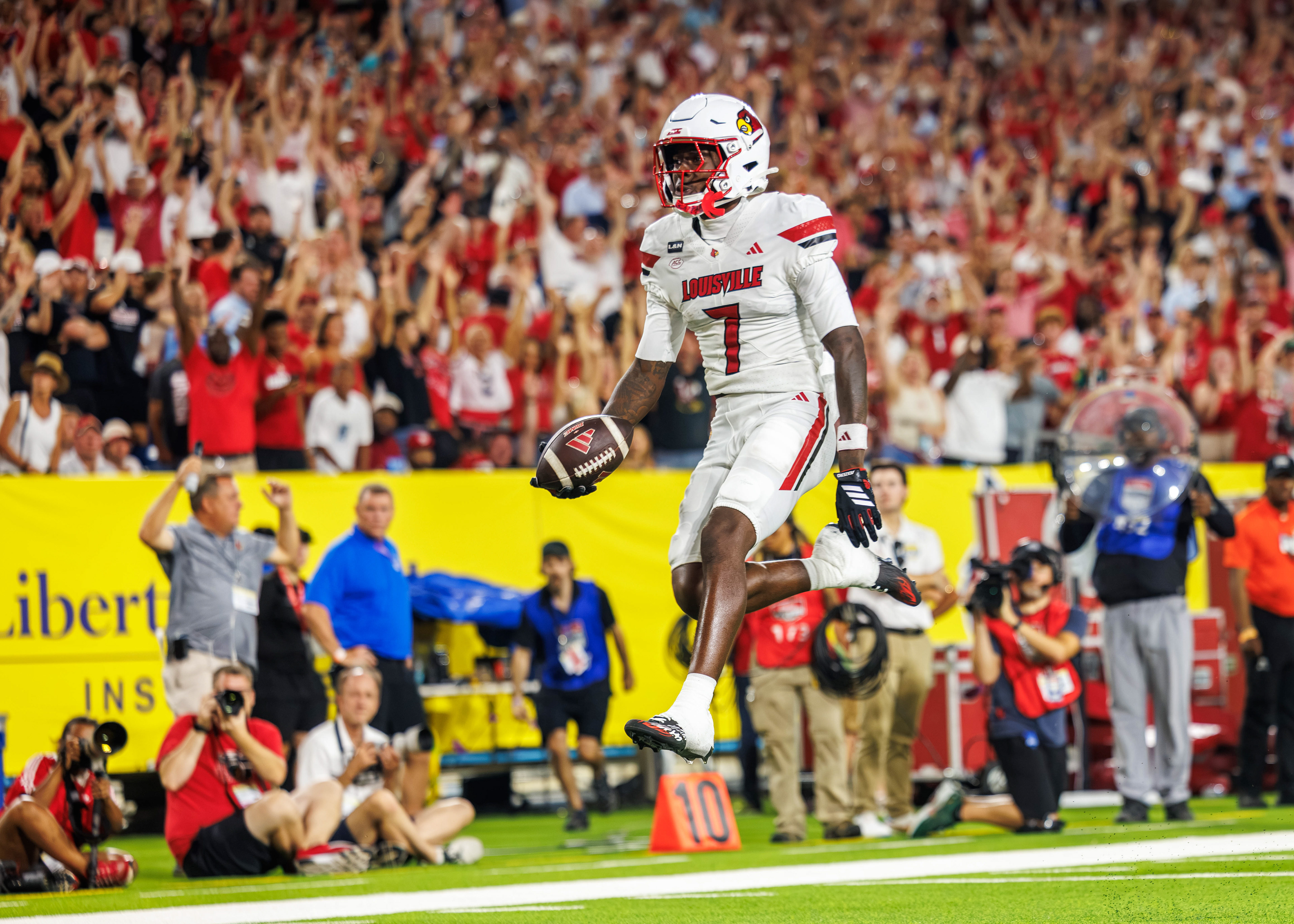 Lawayne McCoy #7 of the Louisville Cardinals leaps into the endzone for a touchdown during the Music City Kickoff between No. 9 Ole Miss and No. 24 Louisville at Nissan Stadium on September 6, 2026 in Nashville, Tennessee. Ole Miss won 41-38 on a walk-off field goal. (Photo by Miles Lineberger for Nashville Sports Council)