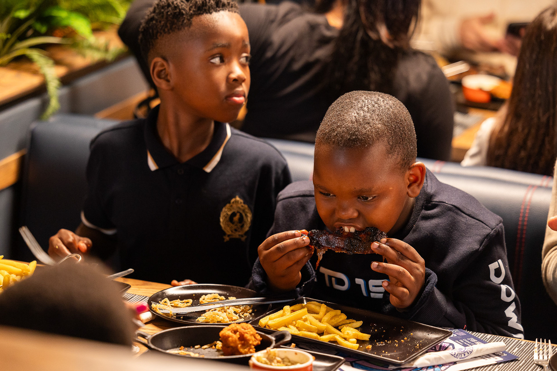 Behind The Scenes image by Ford Creative of two boys enjoying a Spur meal in Cape Town