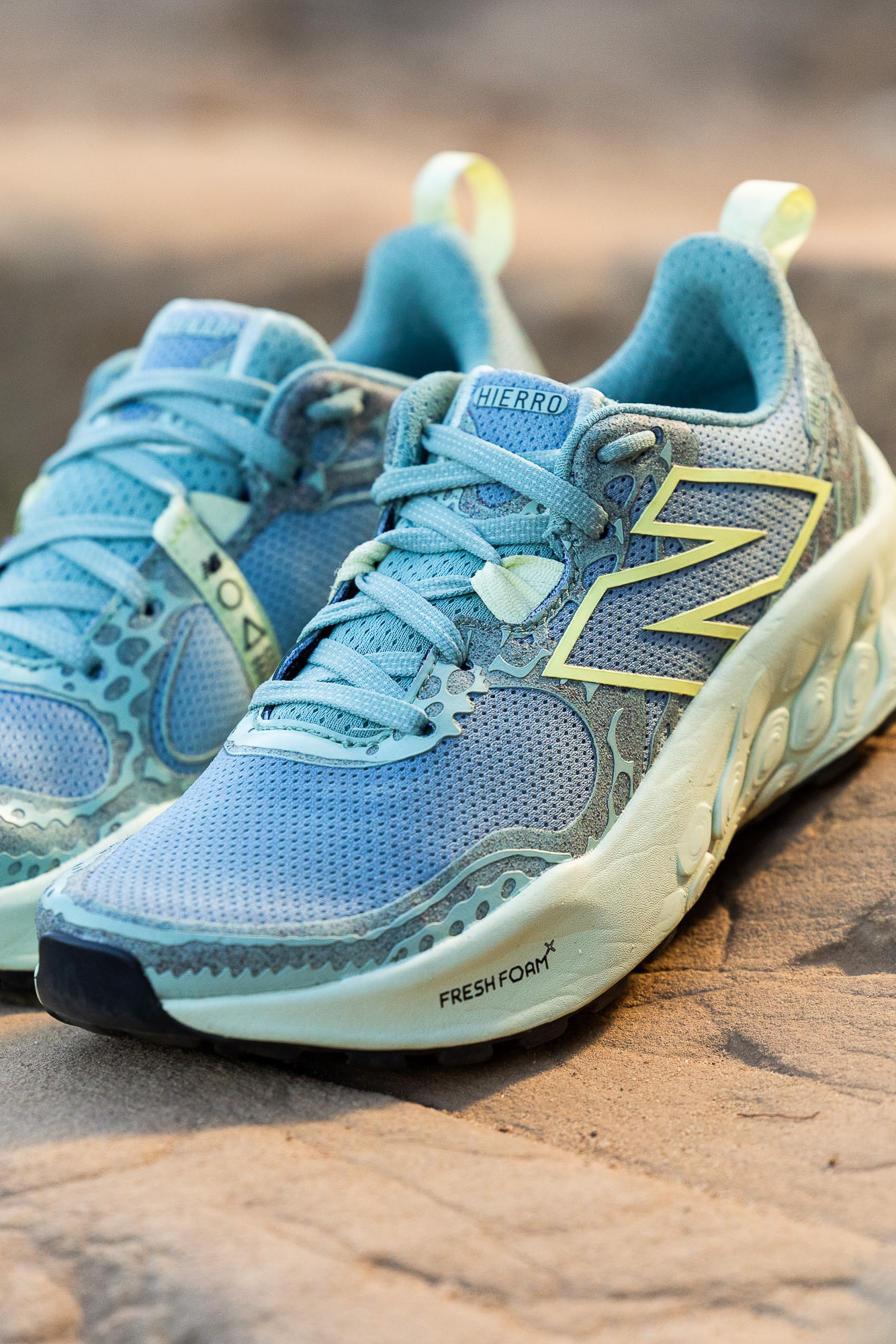A close up of women's New Balance Fresh Foam X Hierro V8 trail shoes on a rock photographed by Casey Crafford