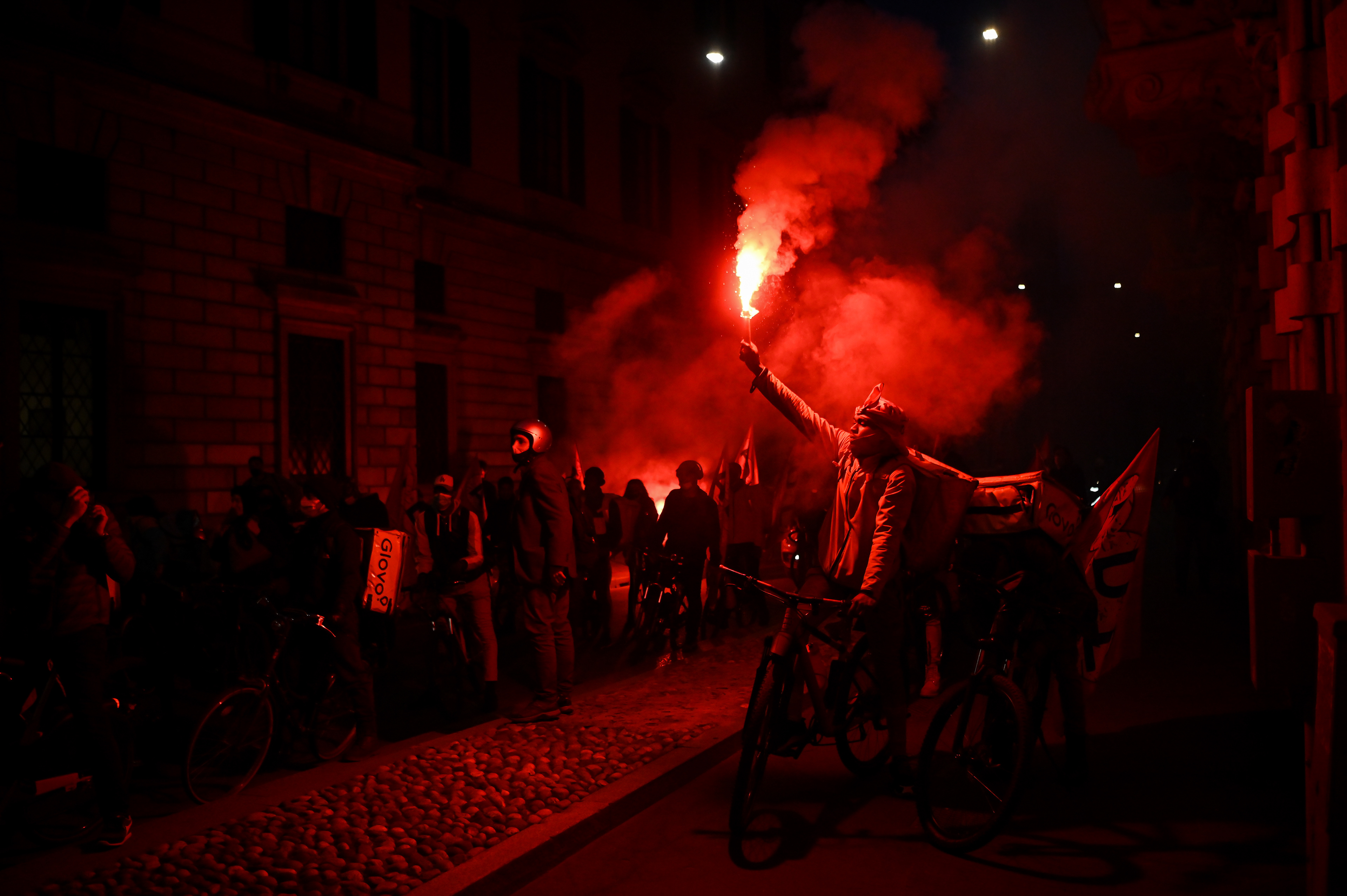 Food delivery riders on their bikes protest amid Coronavirus lockdown restrictions in Milan, Italy on March 26, 2021. Piero Cruciatti / AFP