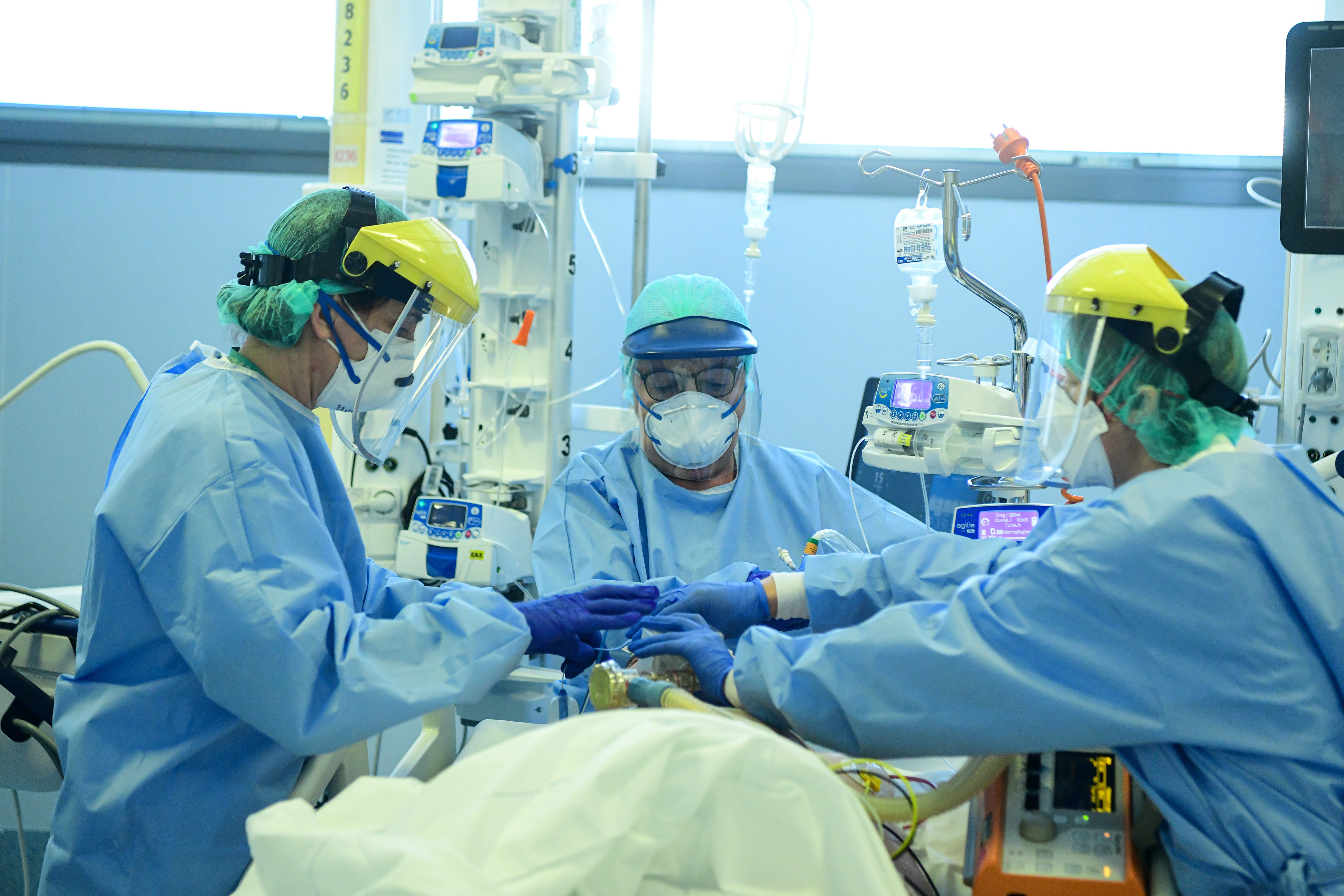 Medical workers in protective gear tend to a patient in the ICU unit at ASST Papa Giovanni XXIII hospital in Bergamo, Italy on April 3, 2020