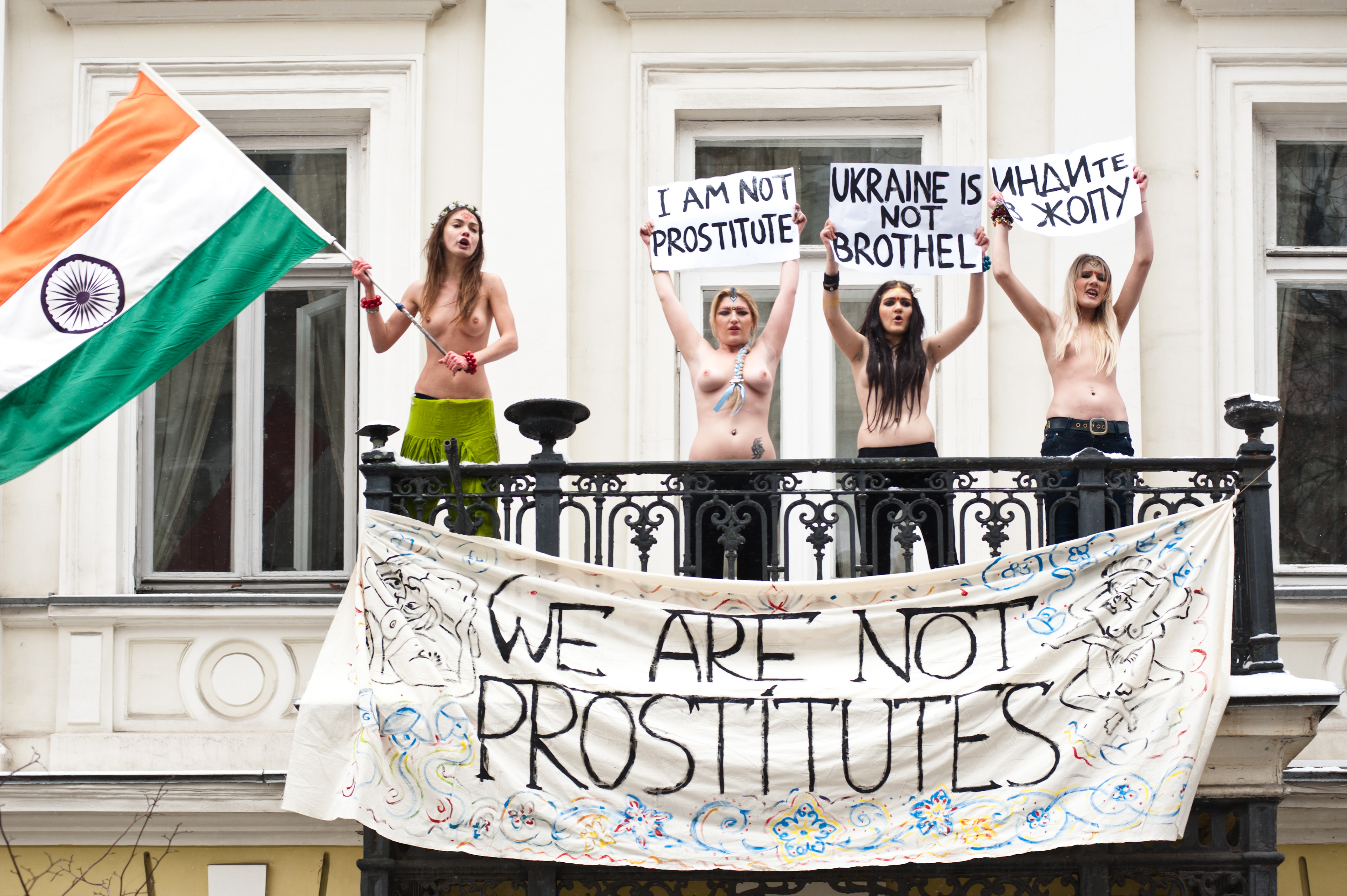 Kiev, January 18, 2012: four FEMEN activists occupied the balcony residence of the Ambassador of India in Ukraine. Activists unfurled a banner on the balcony "We're not prostitutes," shouting "Delhi, close their brothels," "The Ukrainians are not prostitutes!" and "We demand an apology." The four activists were arrested and taken to the police station.  The action was directed against the official policy of the Foreign Ministry of India, urging their ambassady in the CIS countries be scanned women aged 15 to 40 years, traveling to India. Thus, the official Delhi wants to insulate itself from the invasion of post-Soviet women, allegedly responsible for the rapid development of India's sex industry. Oksana Shachko (R)  Fotografo Milano - Photographer Milan 