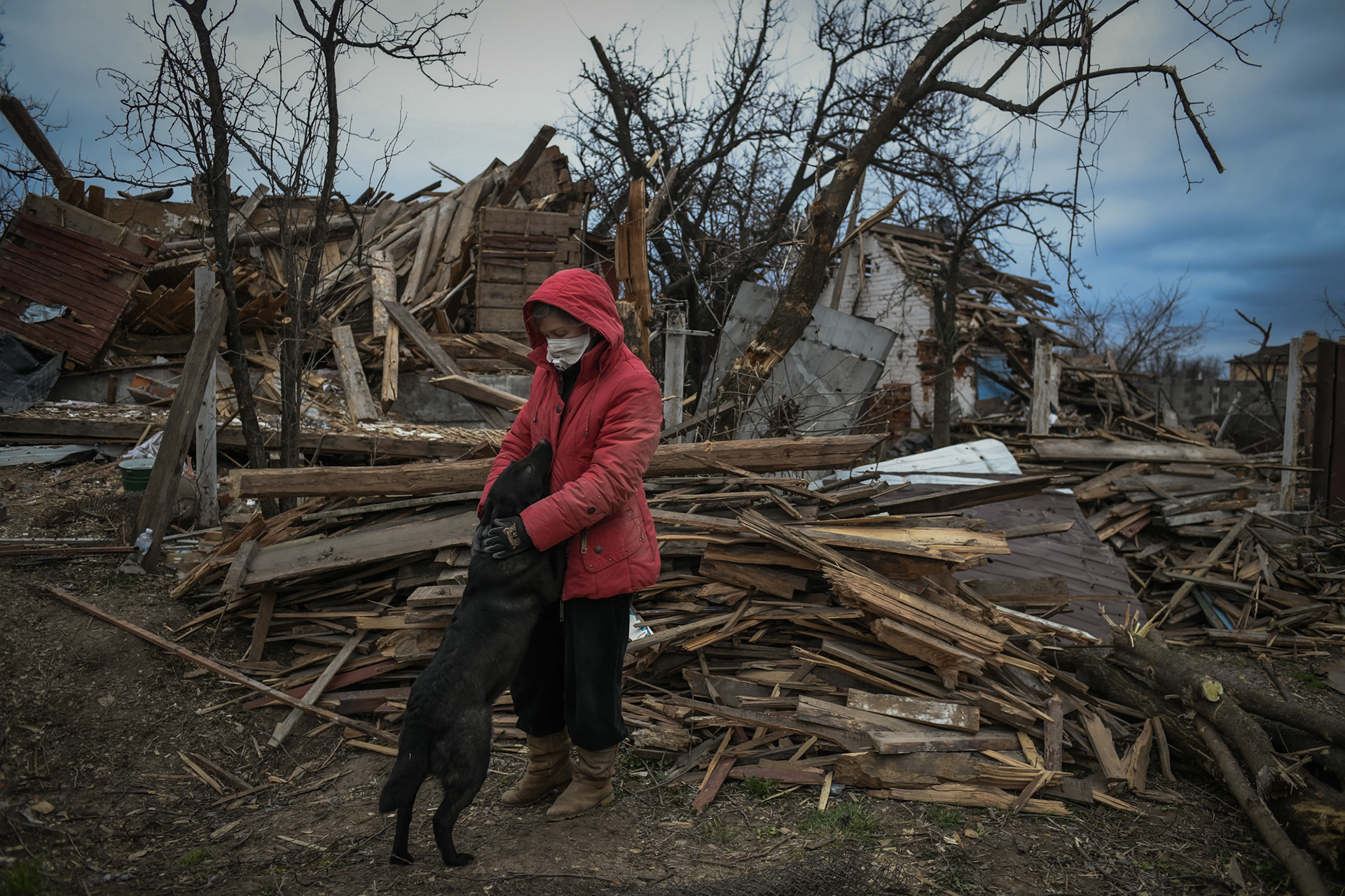 Svetlana, 50, plays with a dog called Mina while removing rubbles from her house destroyed by aviation shellings in a residential area of Chernihiv, Ukraine during the Russian invasion on April 16, 2022.