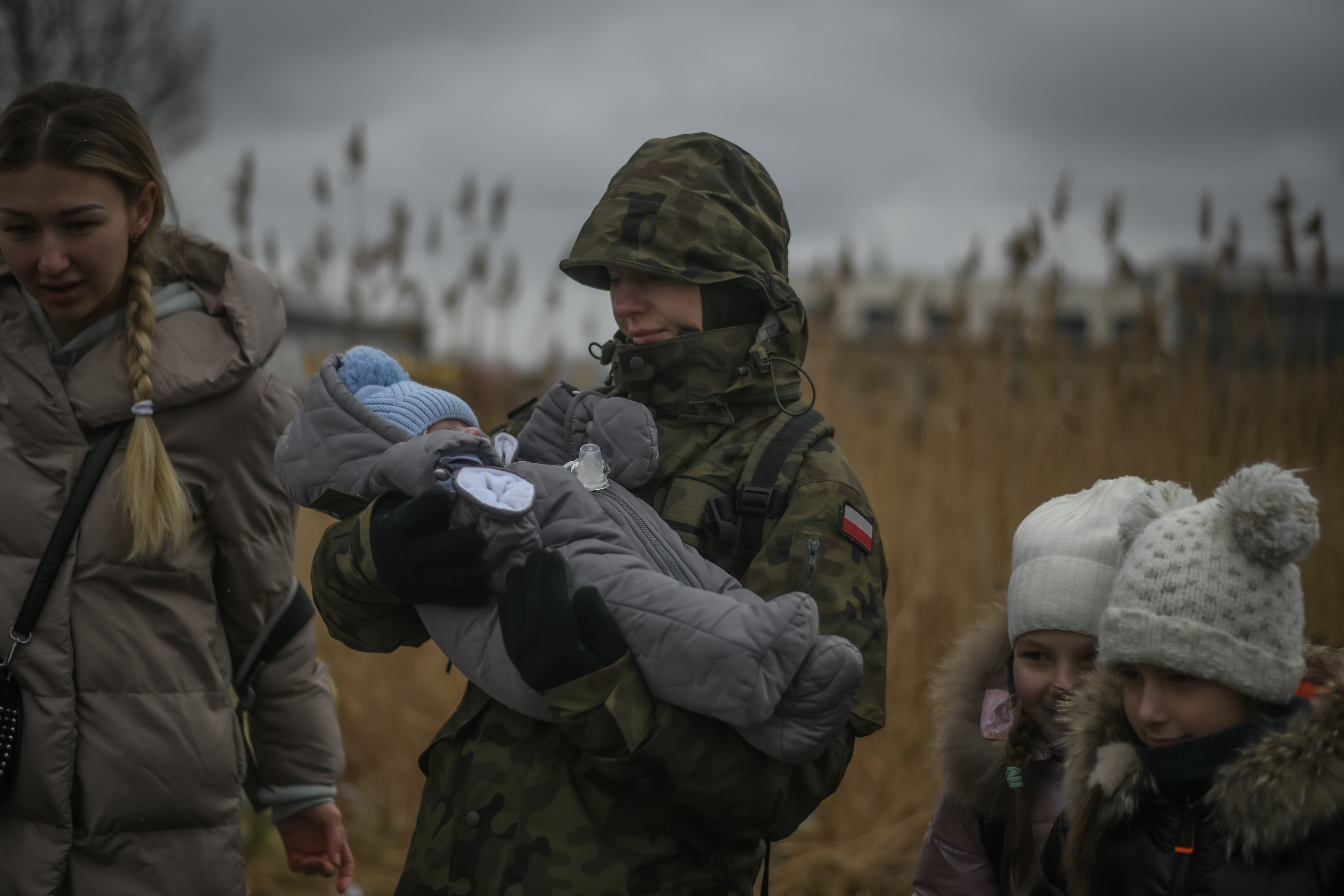 Medyka, Poland, March 9, 2022: a military woman holds a 53 days old baby as they arrive from Ukraine at the Medyka border after Russia launched a full-scale military operation in the country