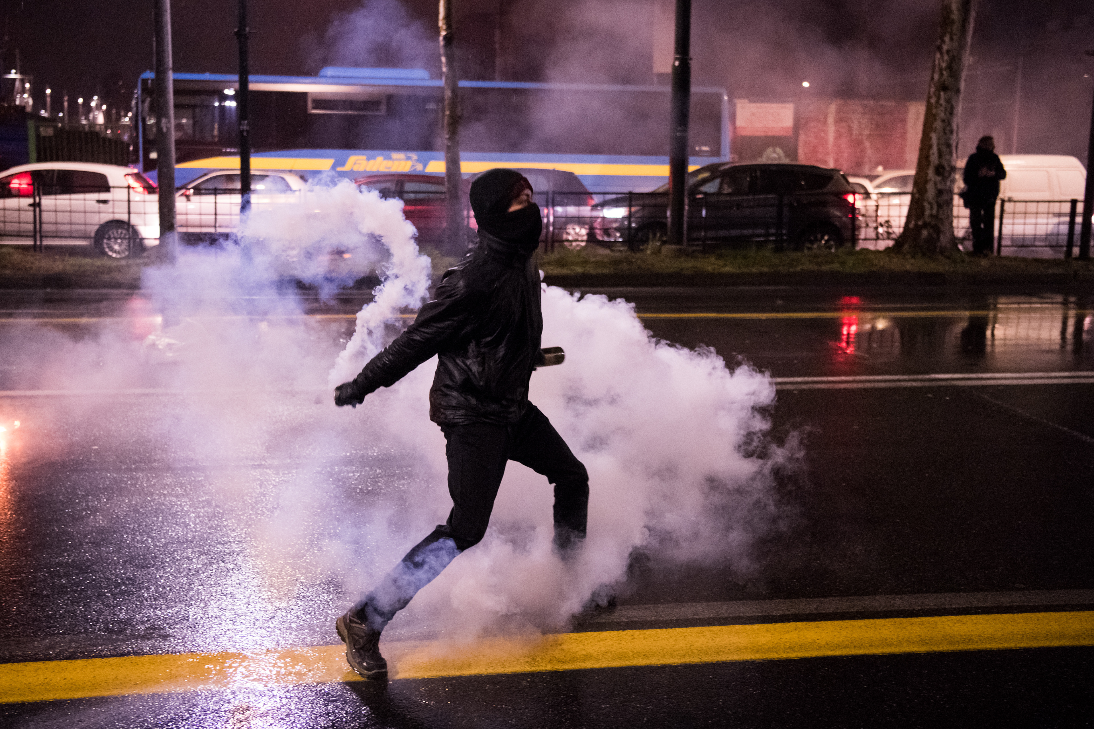 An Antifascist activist throws a bottle at police officers during a rally against an election campaign meeting organized by Italy's far-right movement CasaPound on February 22, 2018 in Turin, Italy. Piero Cruciatti / AFP Photo  photographer milan, fotografo milano