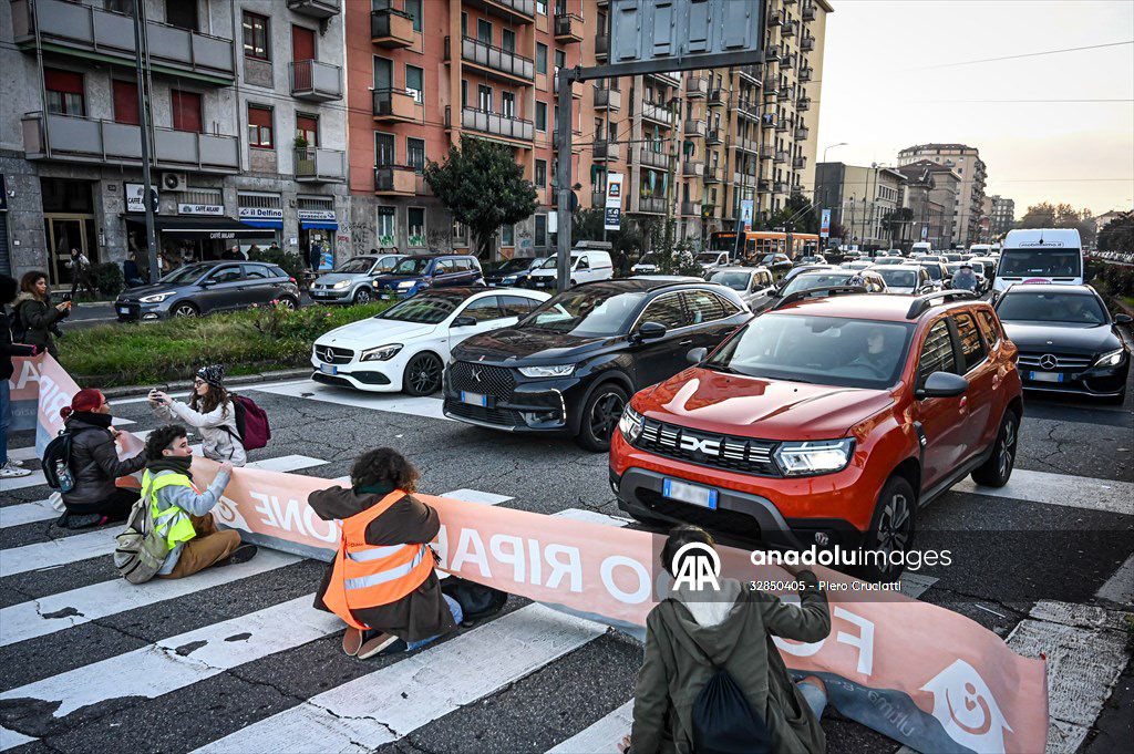 MILAN, ITALY - NOVEMBER 13: Environmental activists by Ultima Generazione block the traffic to raise awareness on climate change in Milan, Italy on November 13, 2023 Fotografo a Milano - Photographer Milan