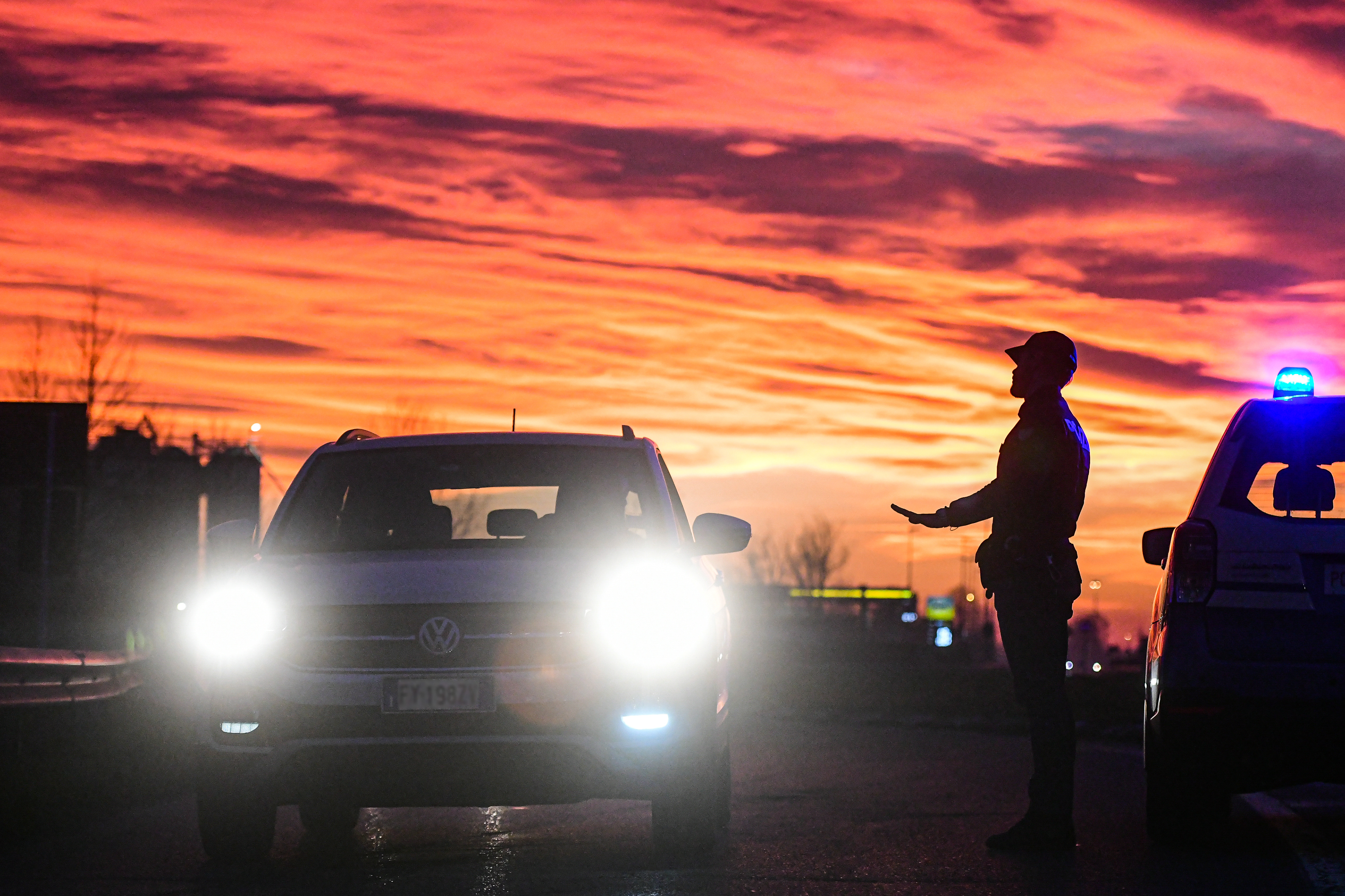 Casalpusterlengo, Italy - 23 February 2020: Italian State Police officers check cars and passengers moving in and out of the city as restrictive measures are taken to contain the outbreak of Coronavirus COVID-19