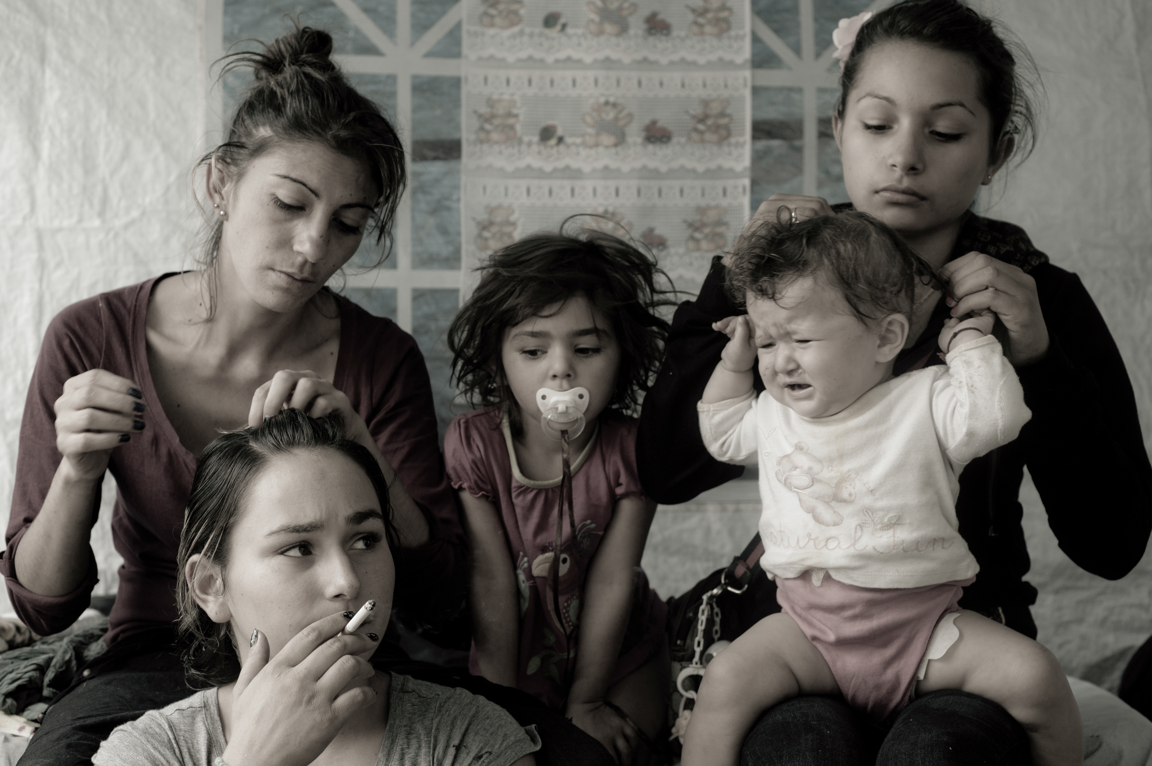 Rome, Italy - 26 September 2012: Bosnian women in a moment of relax two days before being evicted by local police from the Tor de' Cenci 'tolerated' camp. Child marriages and early pregnancies drastically affect the school drop-out rate of young romani girls. Italian authorities often consider early marriage amongst Romani families as a cultural phenomenon without implementing and improving for this reason specific educational projects.
