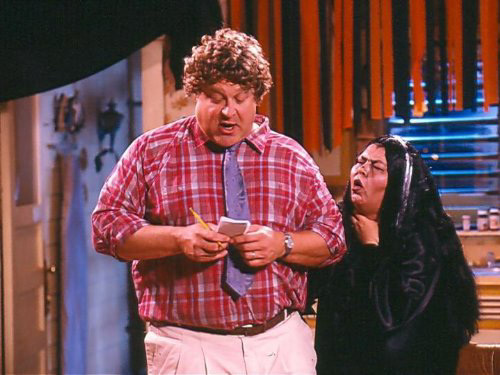 Roseanne image - Dan dressed normally while Roseanne is dressed as a witch behind him