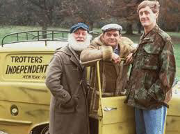 Rodney, Del and Uncle Albert from Only Fools and Horses standing in front of the three wheeled van which has Trotters Independent Traders on it.