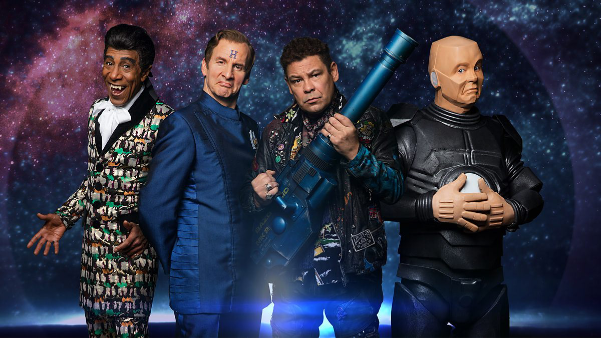 From Red Dwarf: Dave, Lister, The Cat and Kryton all posing in front of the backdrop of space