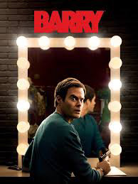 Image of the character Barry looking over his shoulder in front of a brightly lit (showbiz) mirror