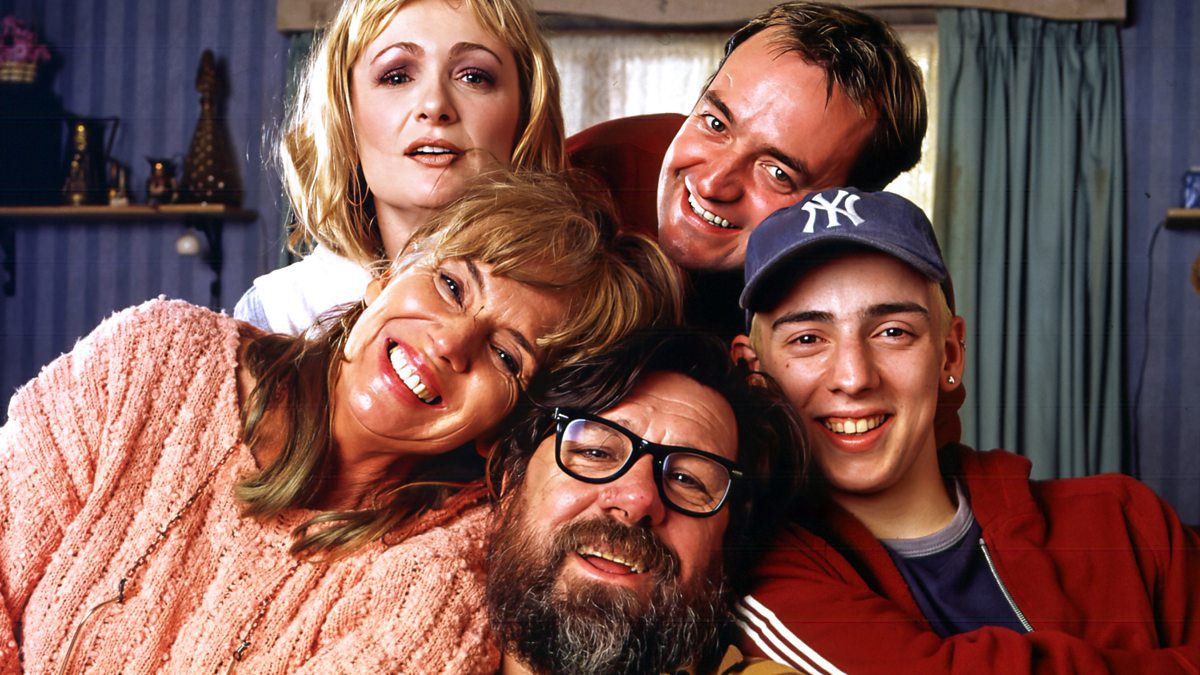 From the Royle Family, Denise, Dave, Mum, Dad, and Lurch smile for the camera apart from Denise who looks confused.