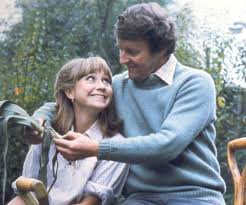 Tom and Barbara sat in front of a tree, They are staring at each other lovingly