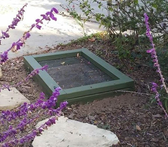 Anti-vermin lid for pit compost.   The raccoons have figured it out though.