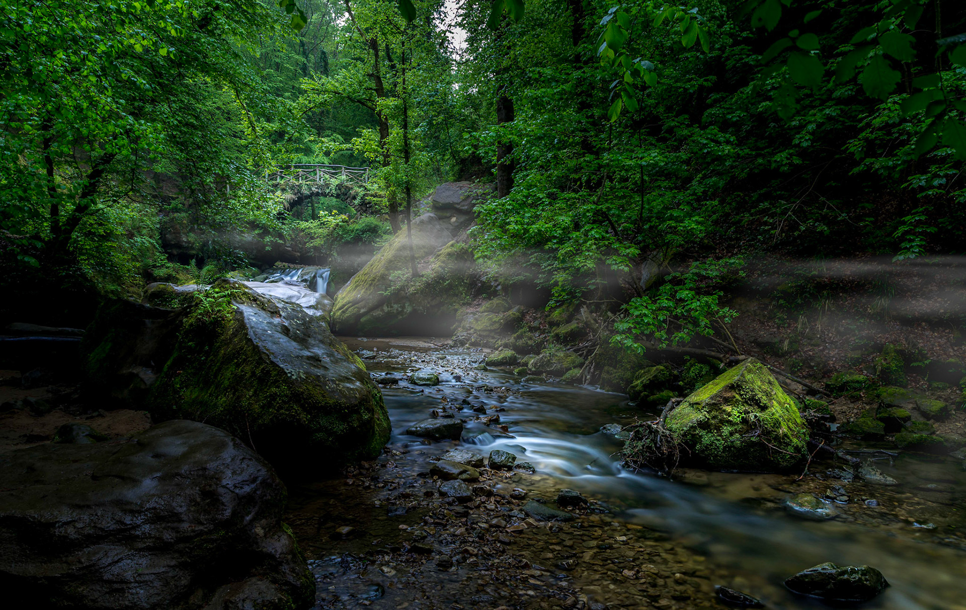 Morning fog in the Schéissendëmpel Waterfall