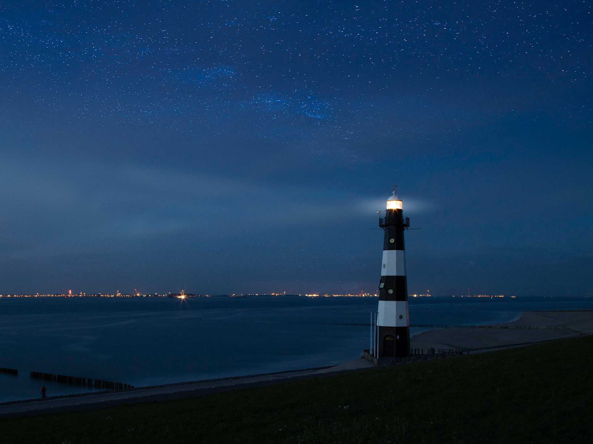 Lighthouse at night with stars