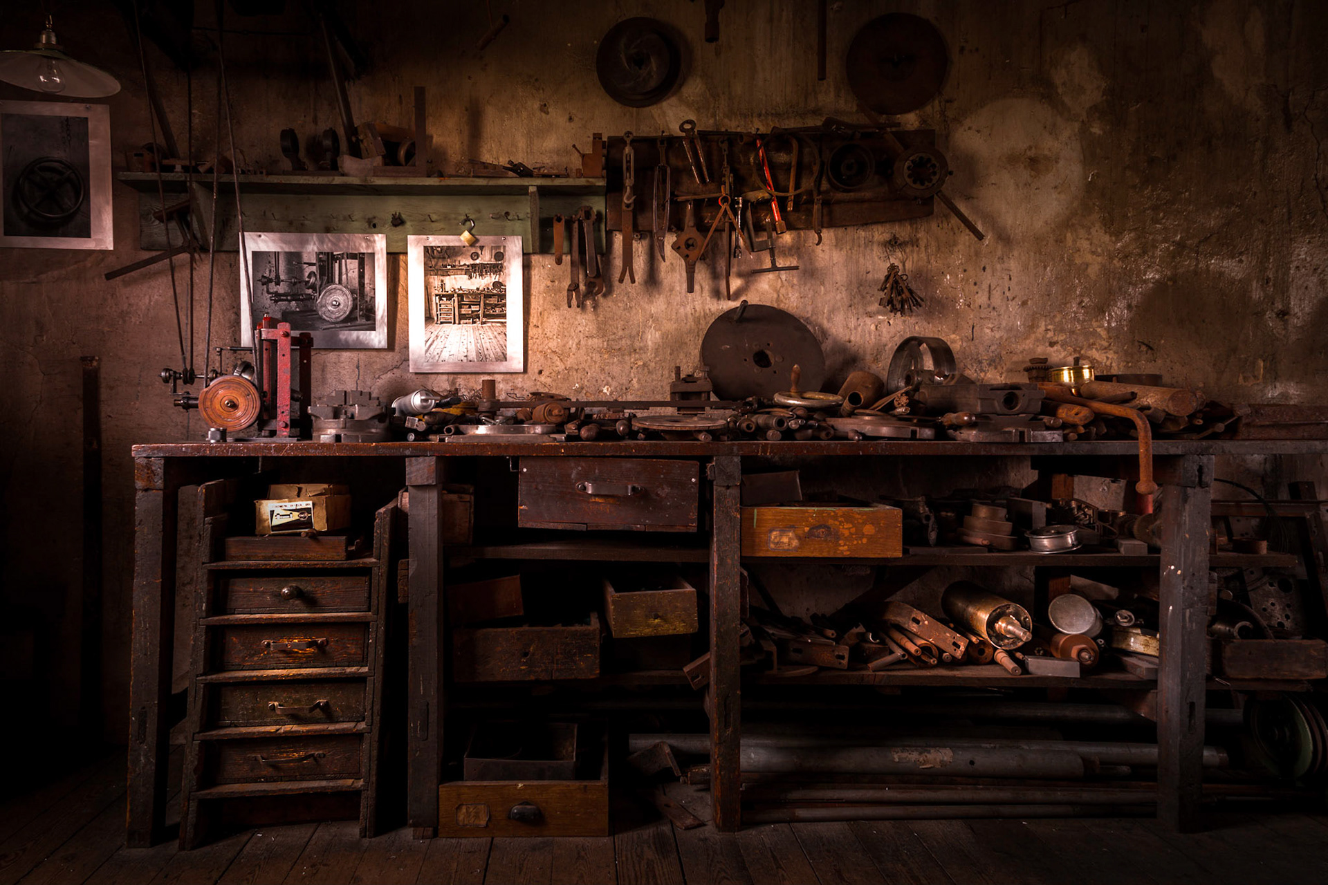 Old table in a metal workshop filled with tools