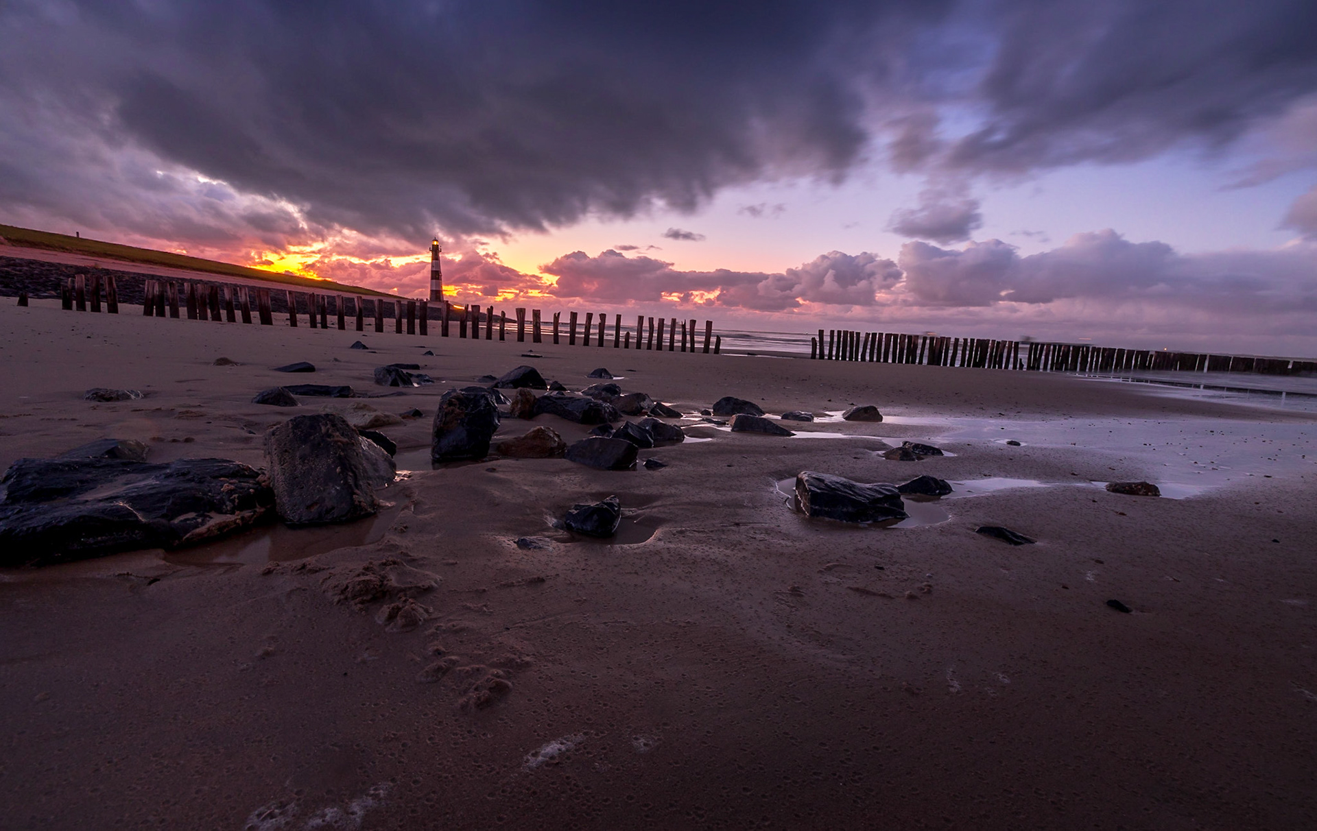 Red sunset in the beach with rocks