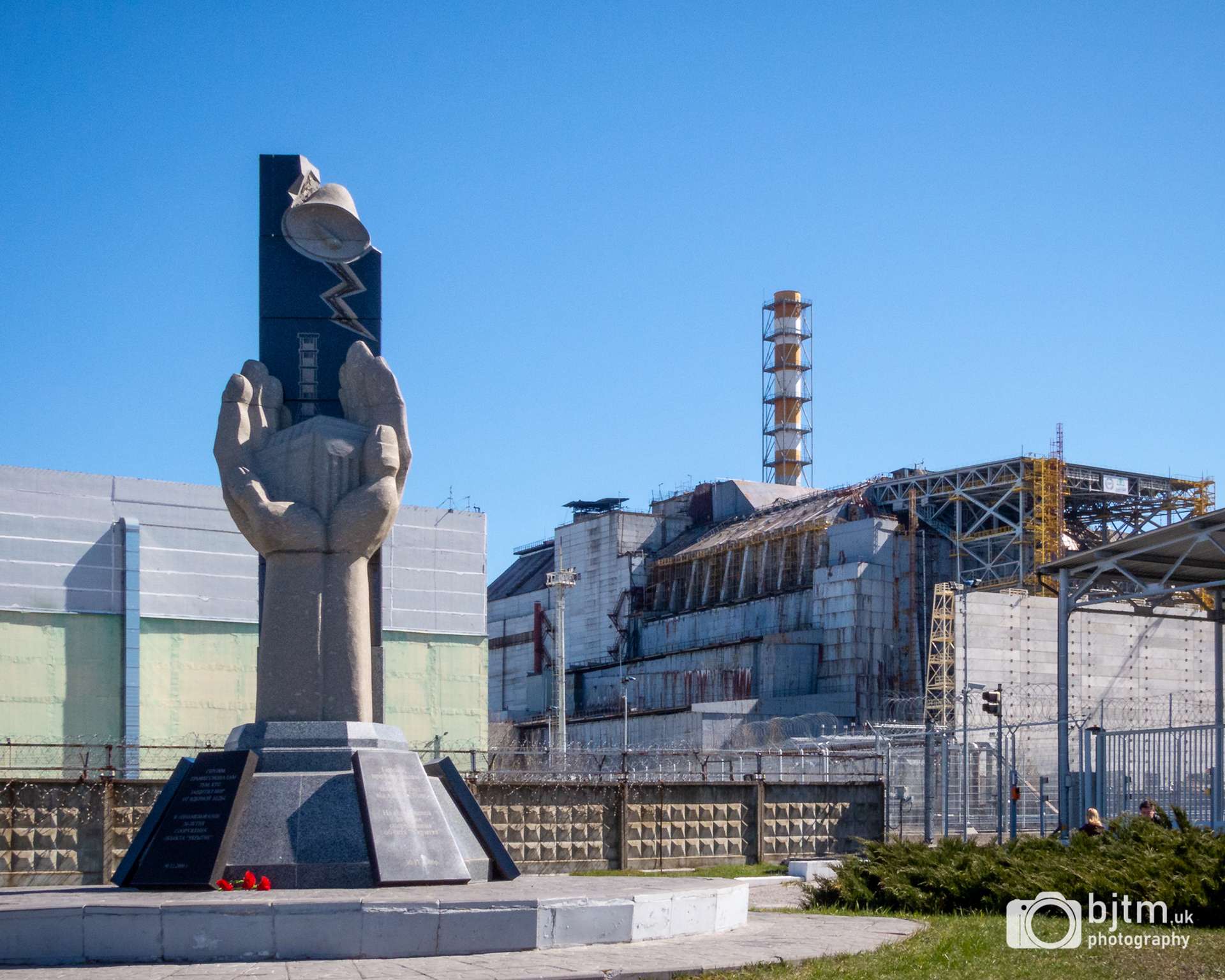 Monument to the disaster and Reactor 4 (now covered by the new containment)
