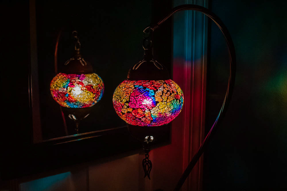 A Turkish lamp next to a mirror.