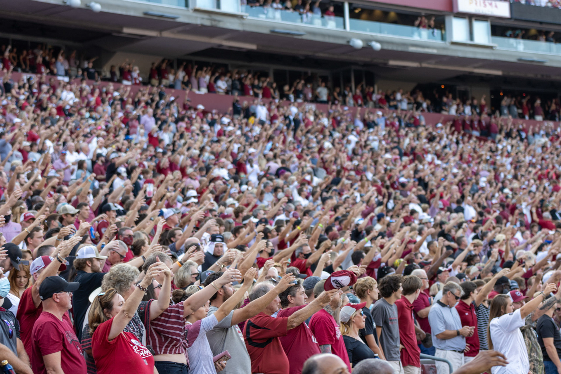 Fans sing the alma mater before the game begins.