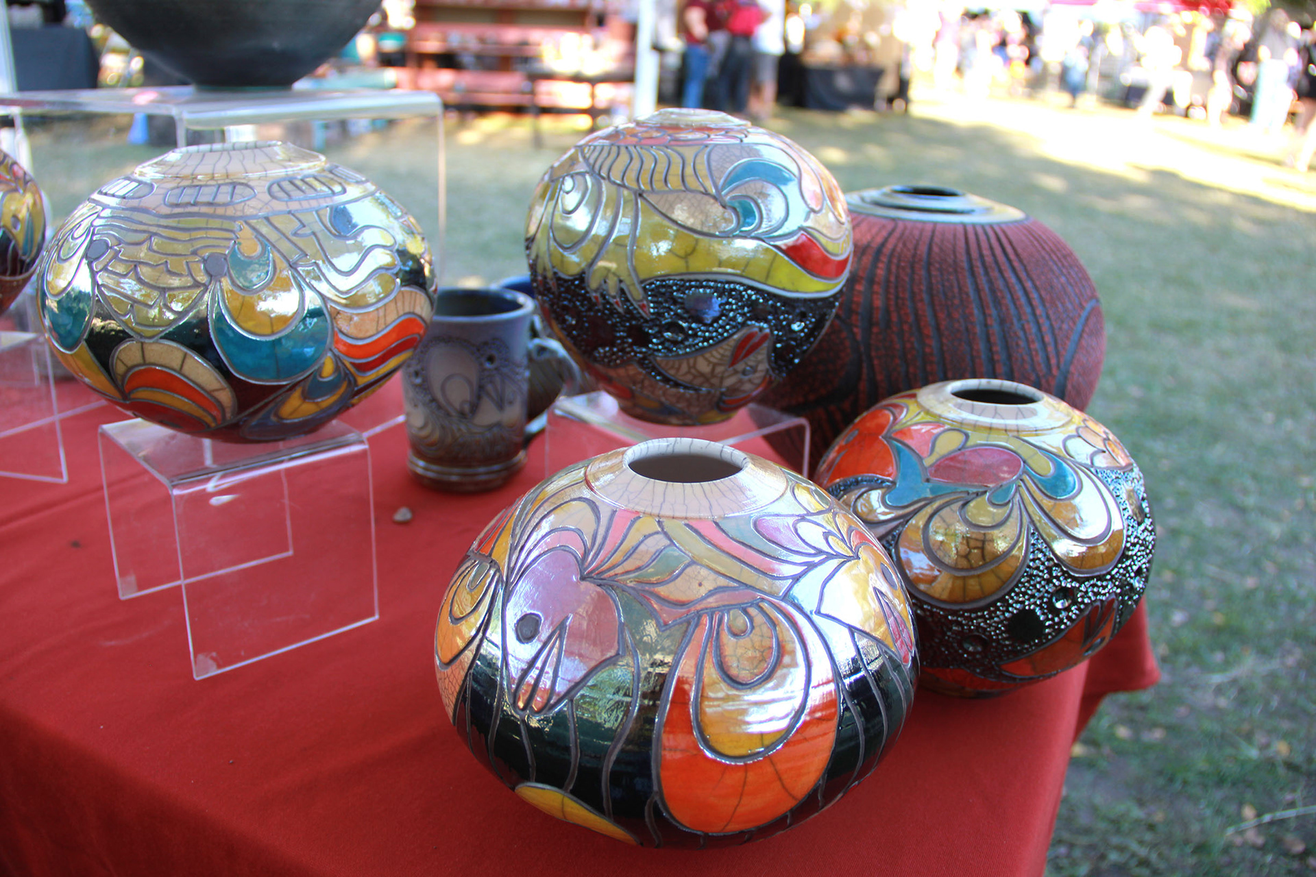 Texas Clay Festival alum Randy Brodnax fired these four metallic vessels by a firing process called Raku.