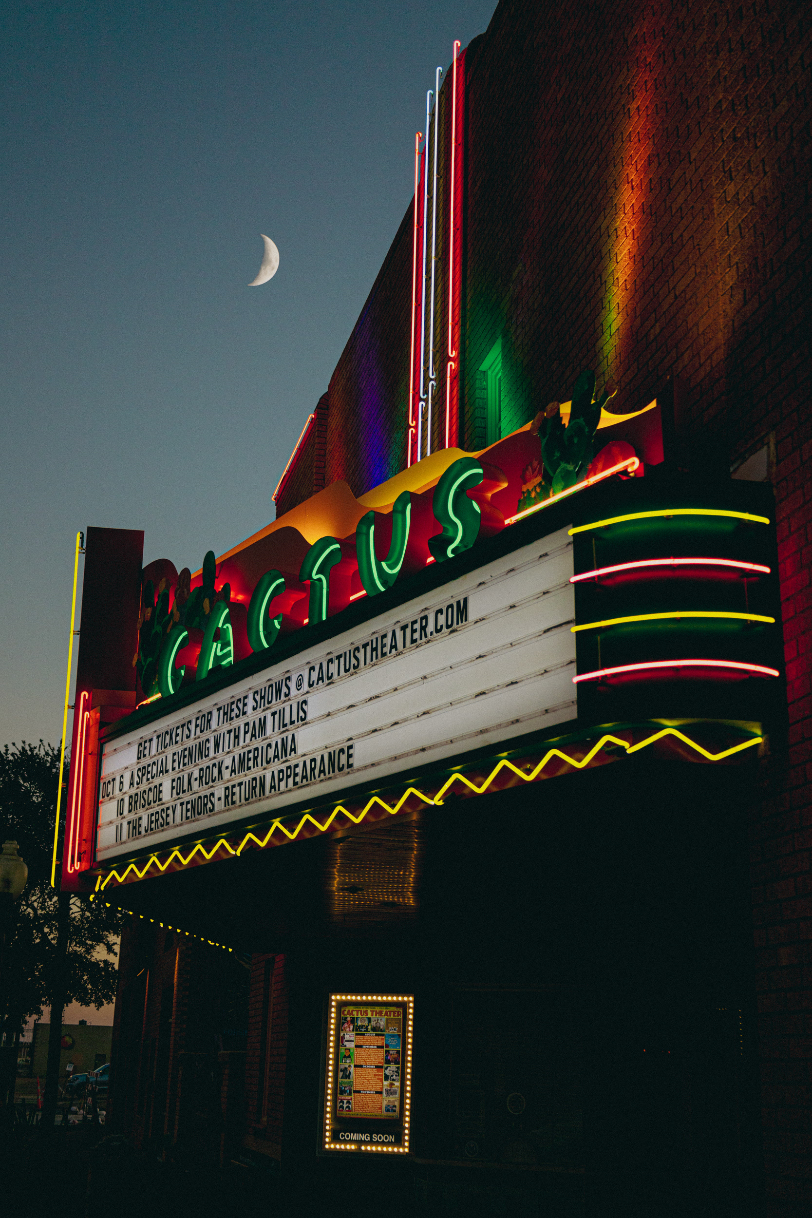 An exceptionally large waxing crescent moon rises over the iconic Cactus Theater on Buddy Holly Ave. in Lubbock, TX