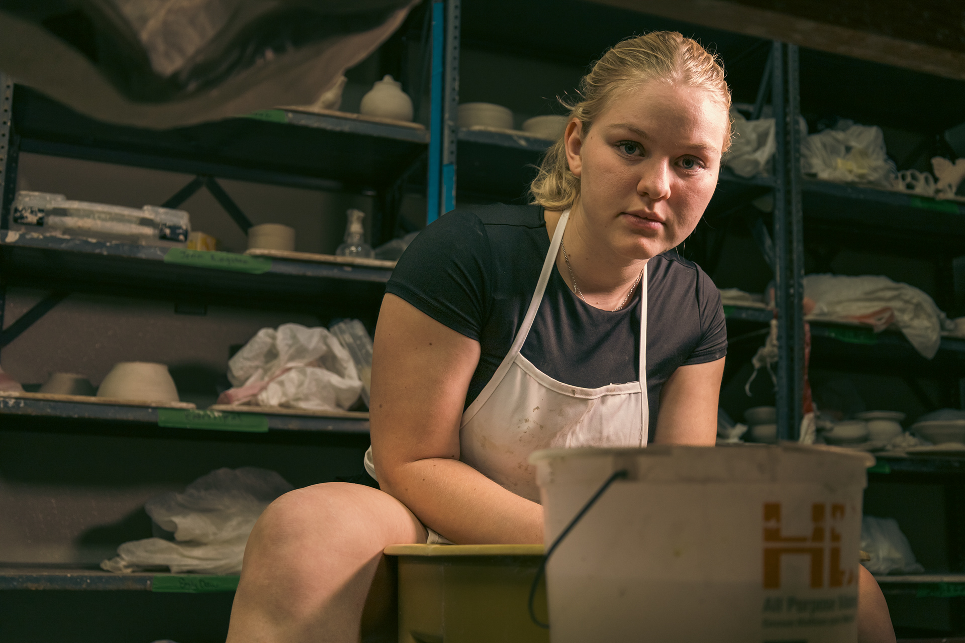 enn Kingston, Texas Tech University School of Art student ceramasict at her pottery wheel in the 3D Art Annex.