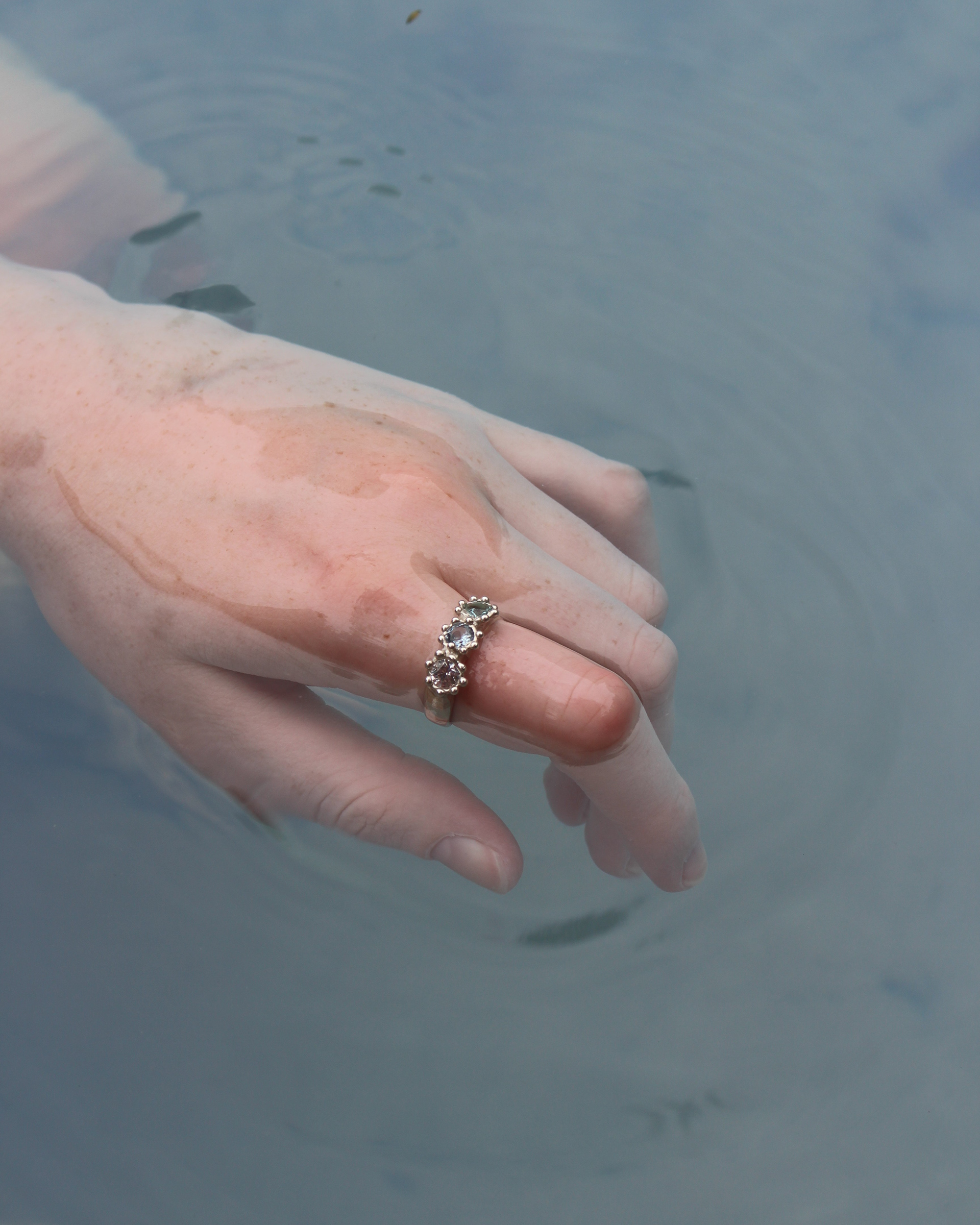 Water Ring, 2022. Sterling silver, lab-grown sapphire.