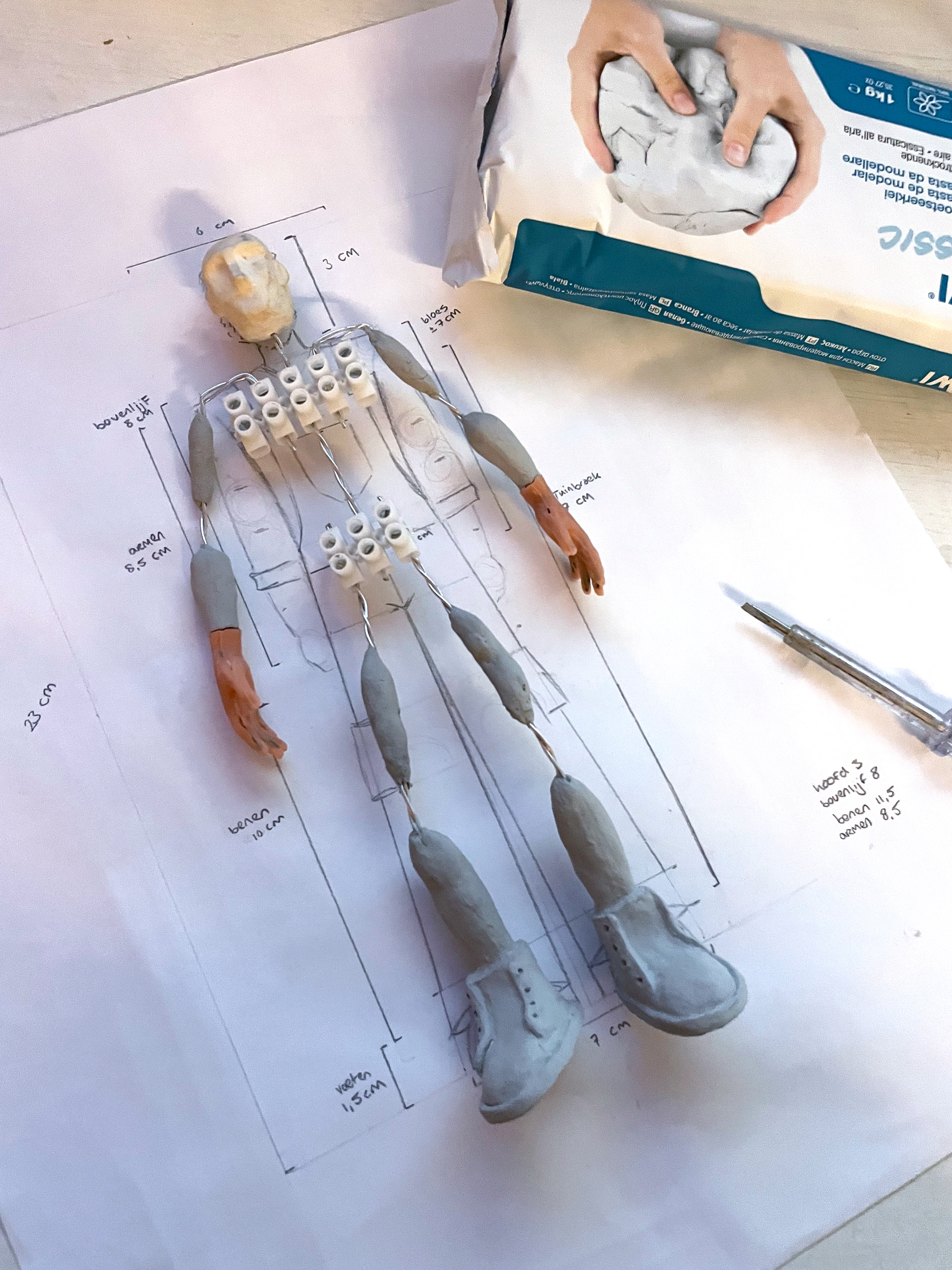 Using clay to make limbs and shoes