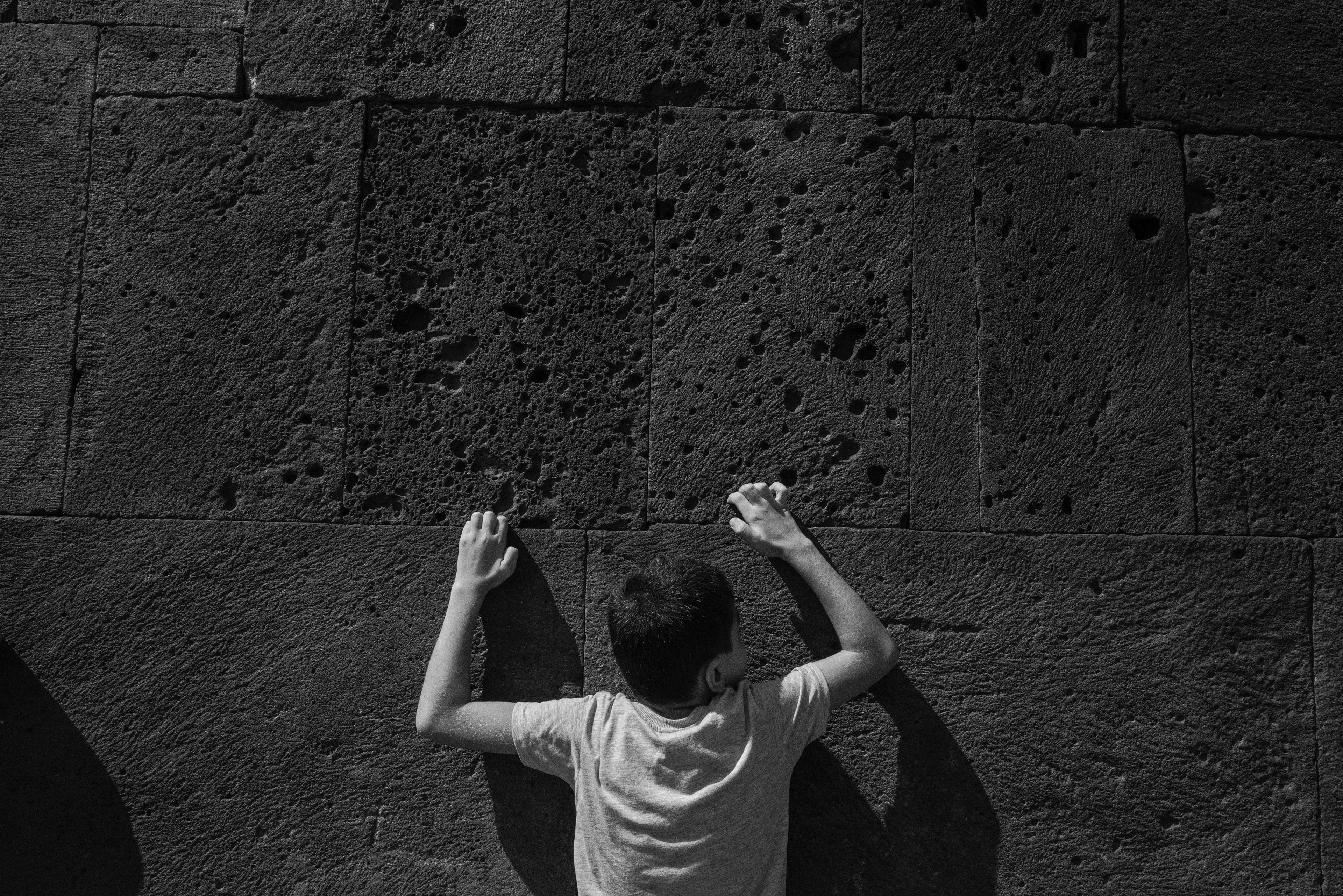 Outside amonastery children try to walk the entire wall over a space of about two centimeters by clinging to the imerfections of the wall surface. If one can do this, it is common belief that you can make a wish. Armenia 2024.