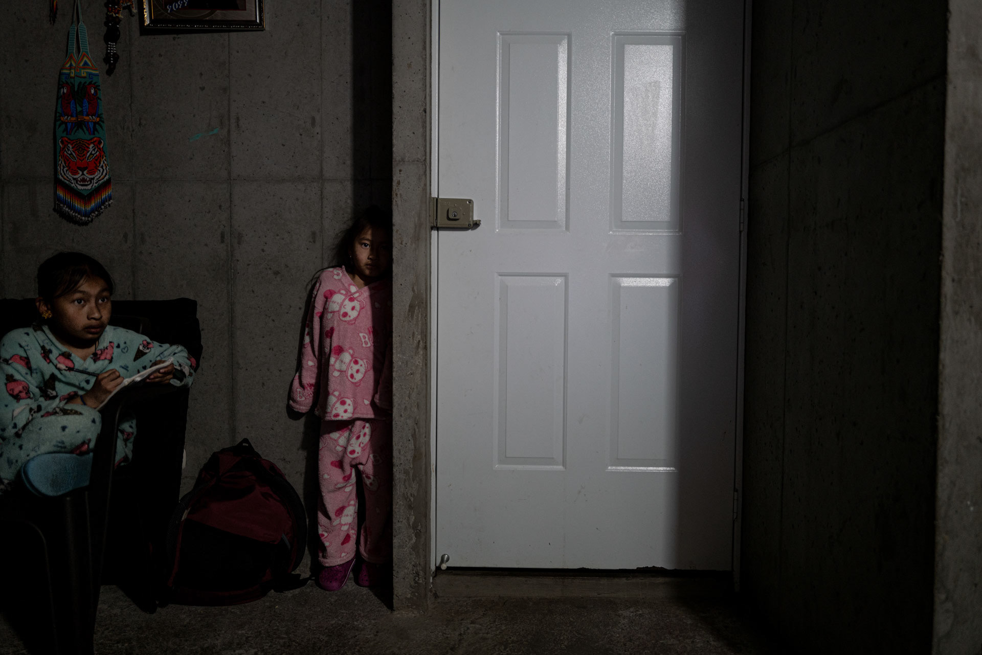 Bogotà Colombia, August 2023. Ana, drawing, and Gisela, playing hide and seek.