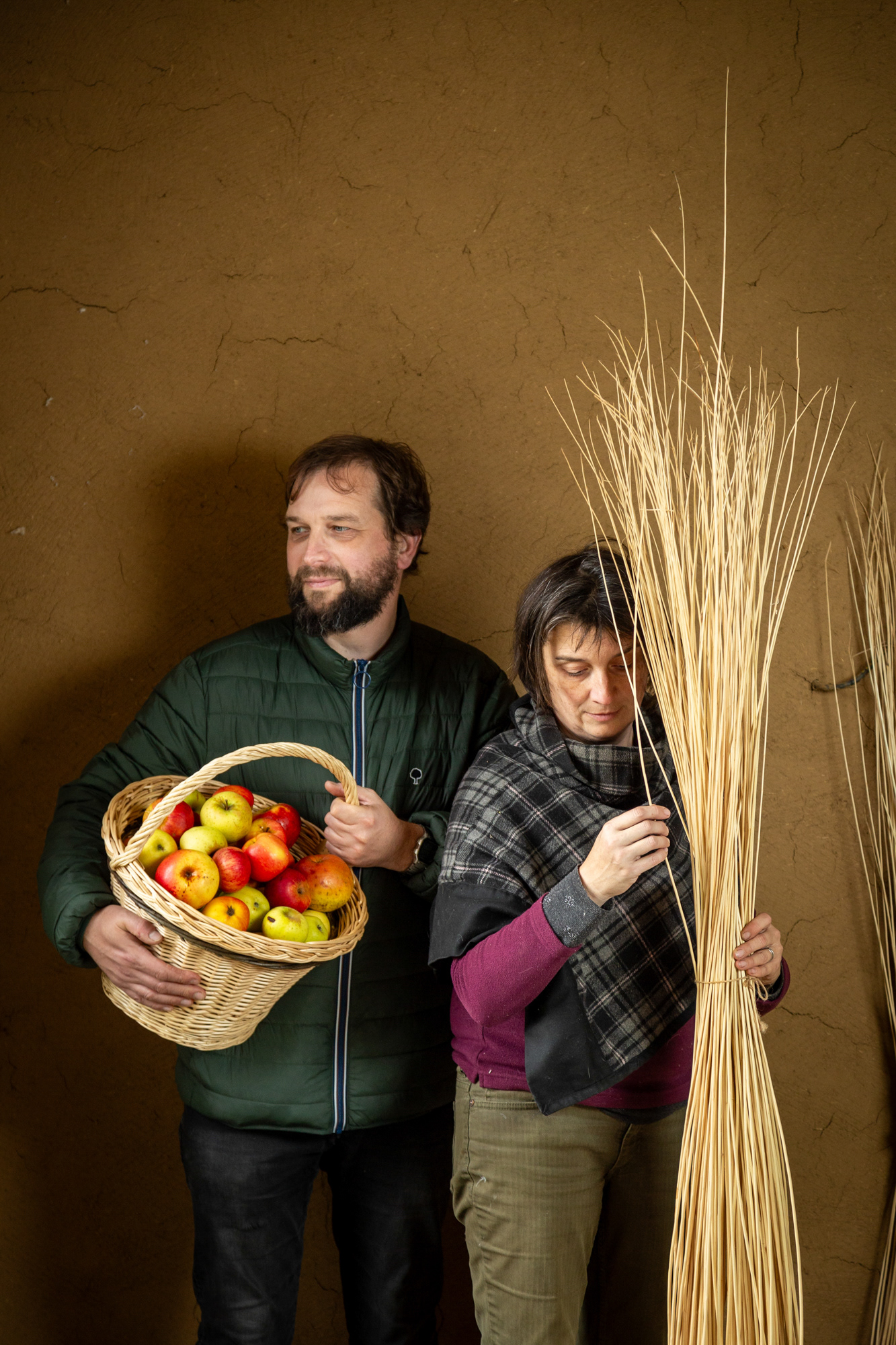 Béatrice et Ludovic Baroux / Vanerie – pressage de pommes et gîtes / Brêmes
Béatrice : Nous sommes en plein travaux. Dans ce corps de ferme qui a appartenu à mes parents, nous aménageons des gîtes de la façon la plus écologique possible.
Ludovic : Nous avons suivi des ateliers autour de la limitation des déchets et ça a été comme un déclencheur pour nous. Ici, les enduits sont en terre crue, l'isolant en fibre végétale. Pour l'eau nous allons mettre en place une phytoépuration, c'est un bassin avec des roseaux qui filtrent les eaux usées.
Béatrice : C'est aussi un lieu qui vie déjà avec nos autres activités, Ludovic a sa micro-entreprise de pressage de pommes, avec des fruits venant de particuliers et de producteurs locaux. De mon côté, j'ai débuté la vannerie et j'ai installé mon atelier dans la maison de mes parents. On teste des plans d'osiers dans notre jardin, c'est un lieu d'expérimentation !