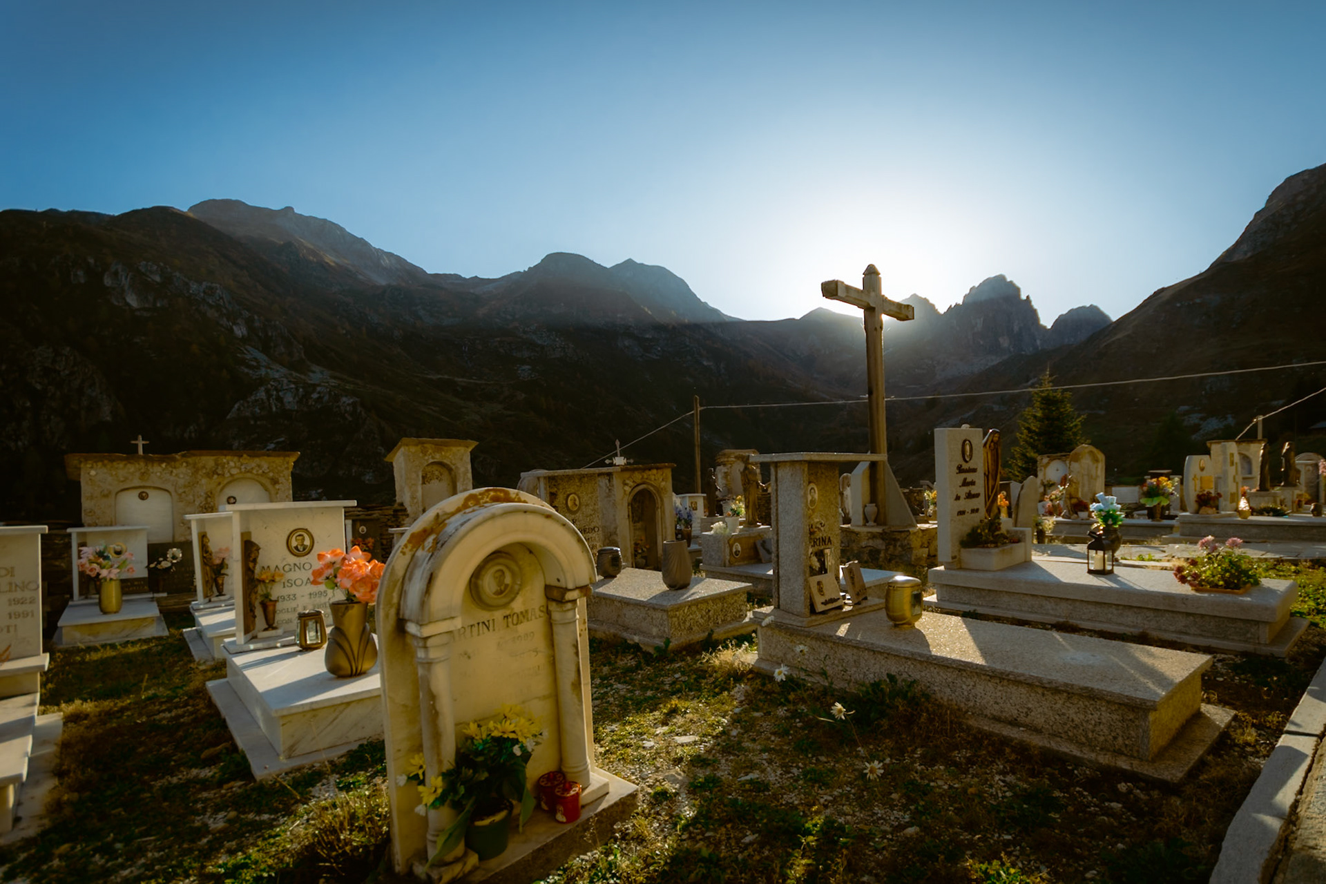 The sun sets in front of the cloister's cemetery.