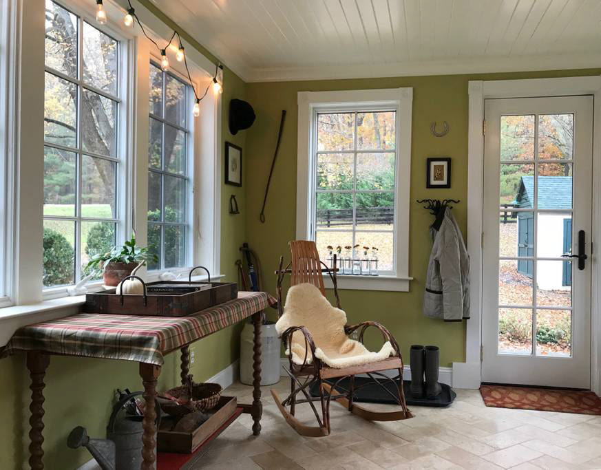 The sunroom is cozy in winter with underfloor heating. French doors lead out to the deck.