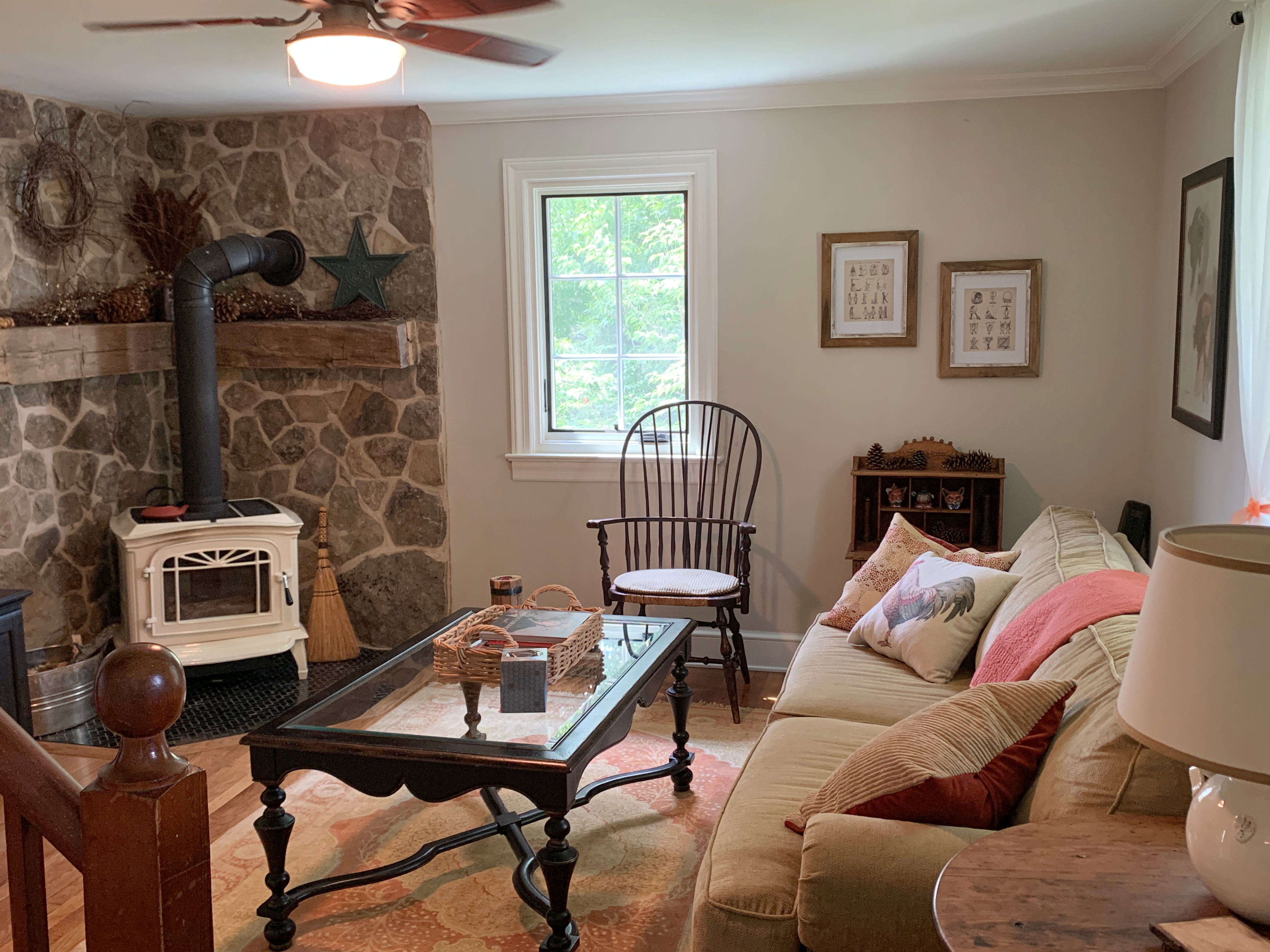 The living room with a woodturning stove, large screen tv (dish network), stereo and DVD player.