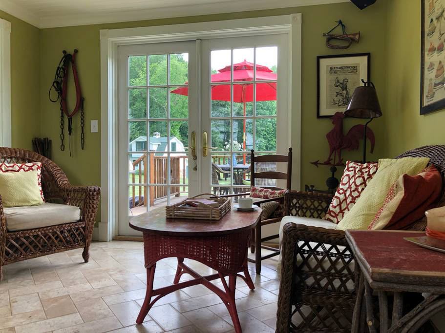 Looking back to the deck and yard from the sunroom. The floor is heated so it is lovely place to hang out in colder months.
