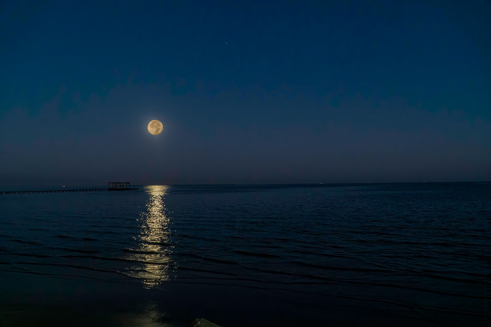 Full moon rising over Galveston Bay