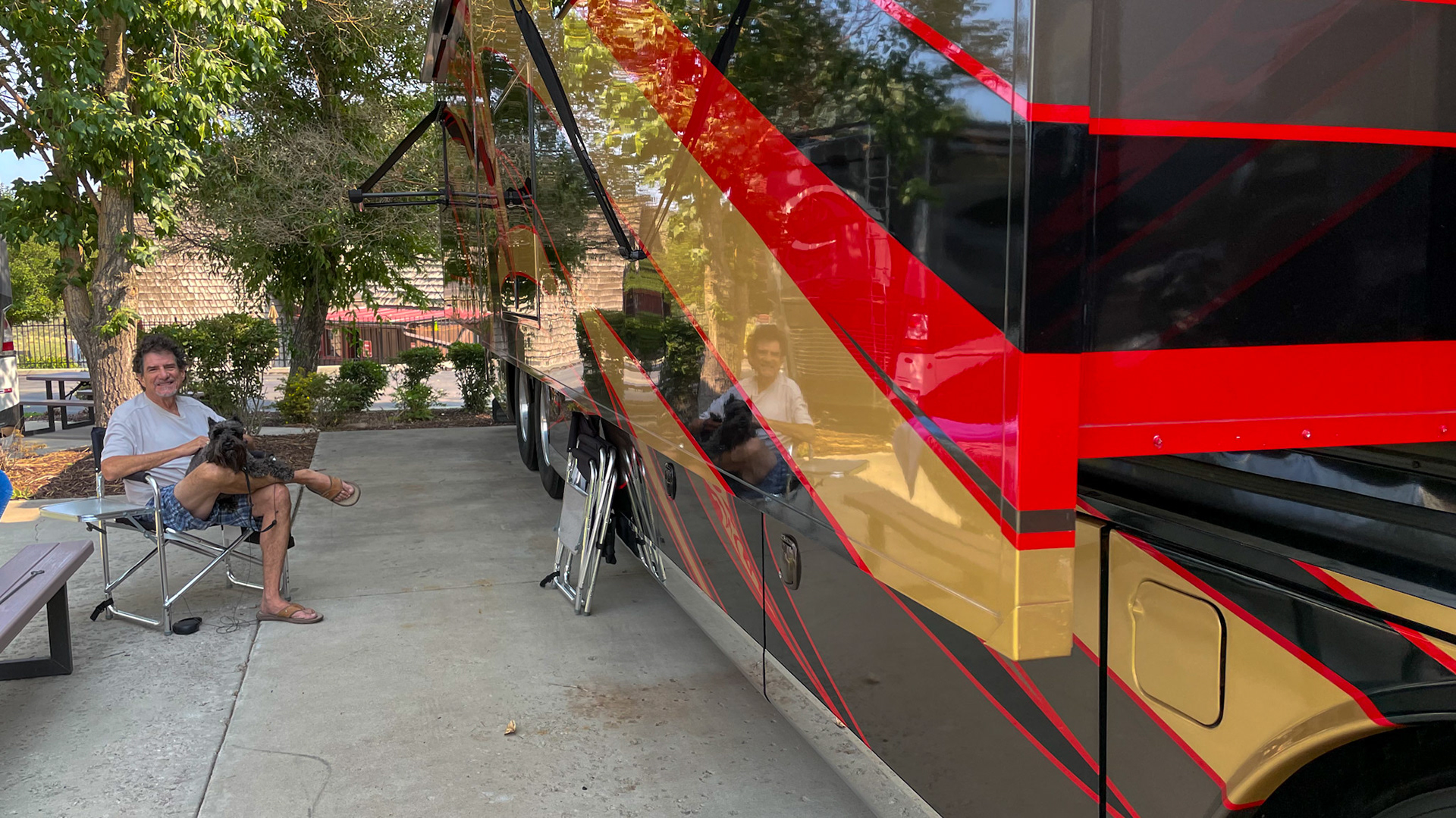 Relaxing on the patio near the shiny RV