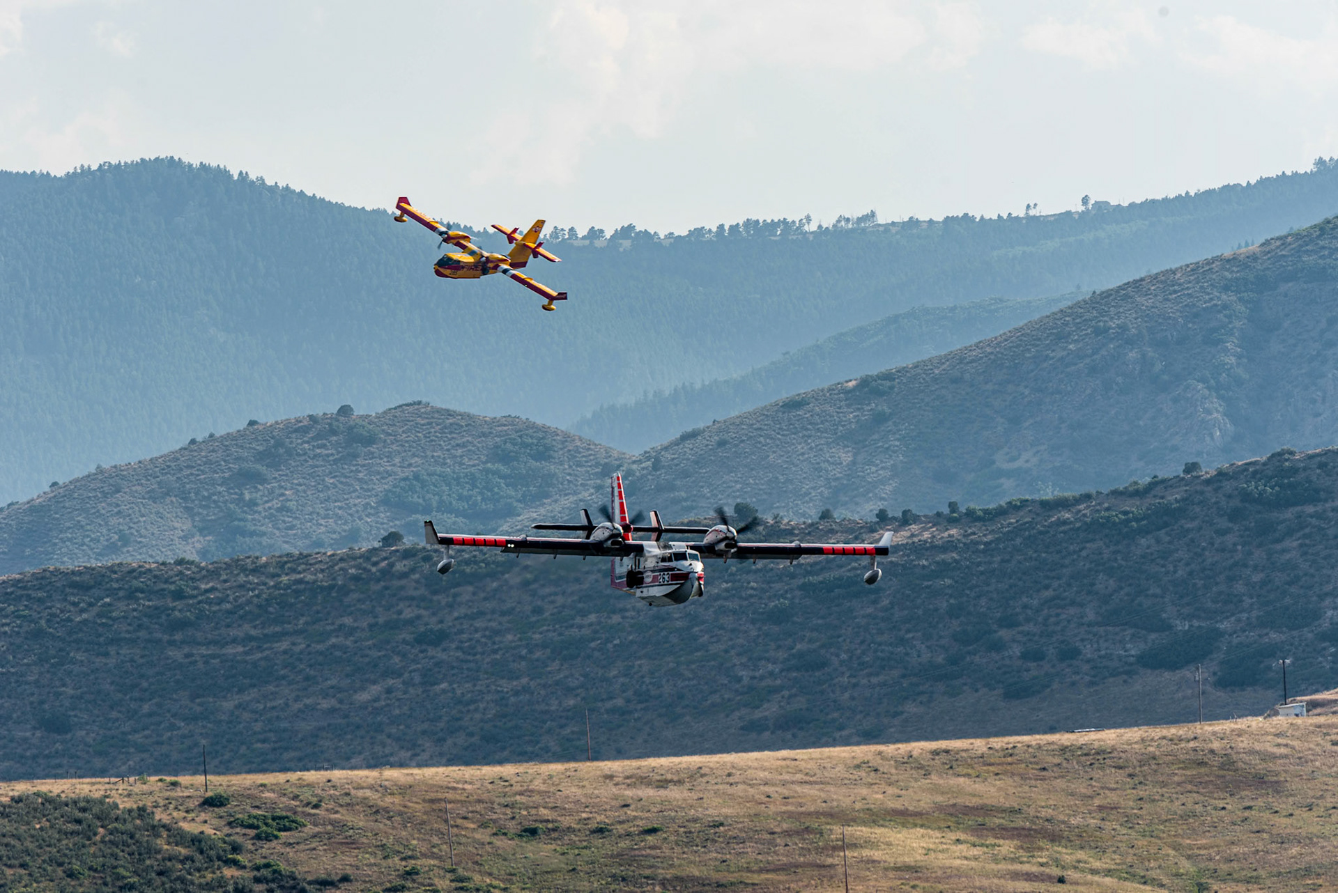 Fire fighting planes lining up for a fillup on the lake