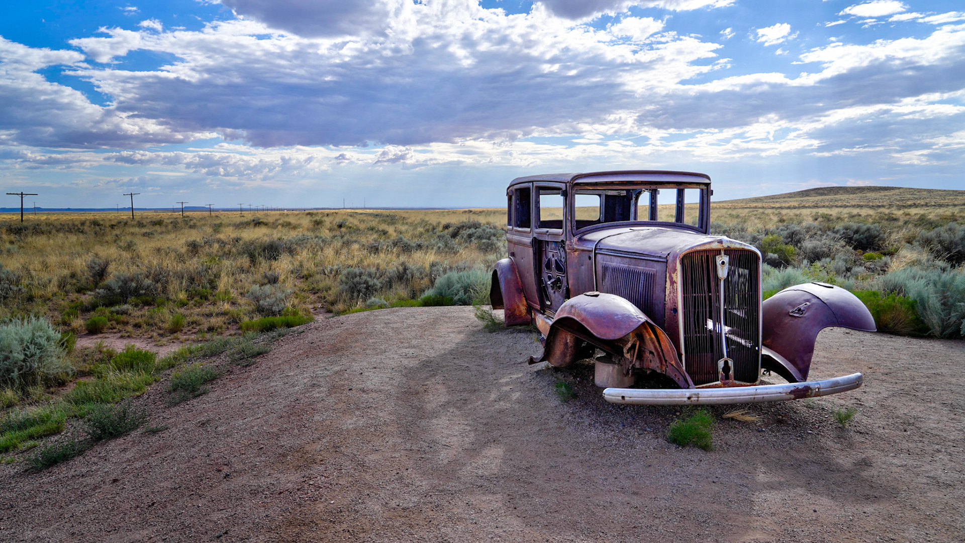 Telephone poles and an old Studebaker mark the old Route 66
