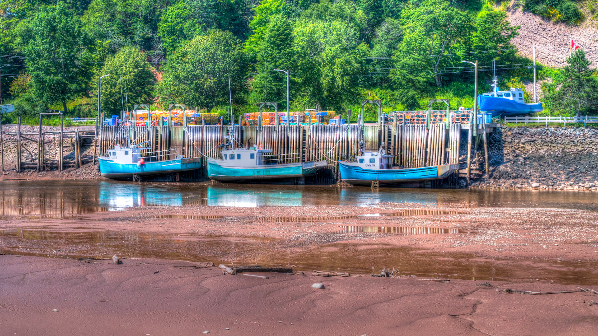 Boats at low tide in the harbour at St Martins