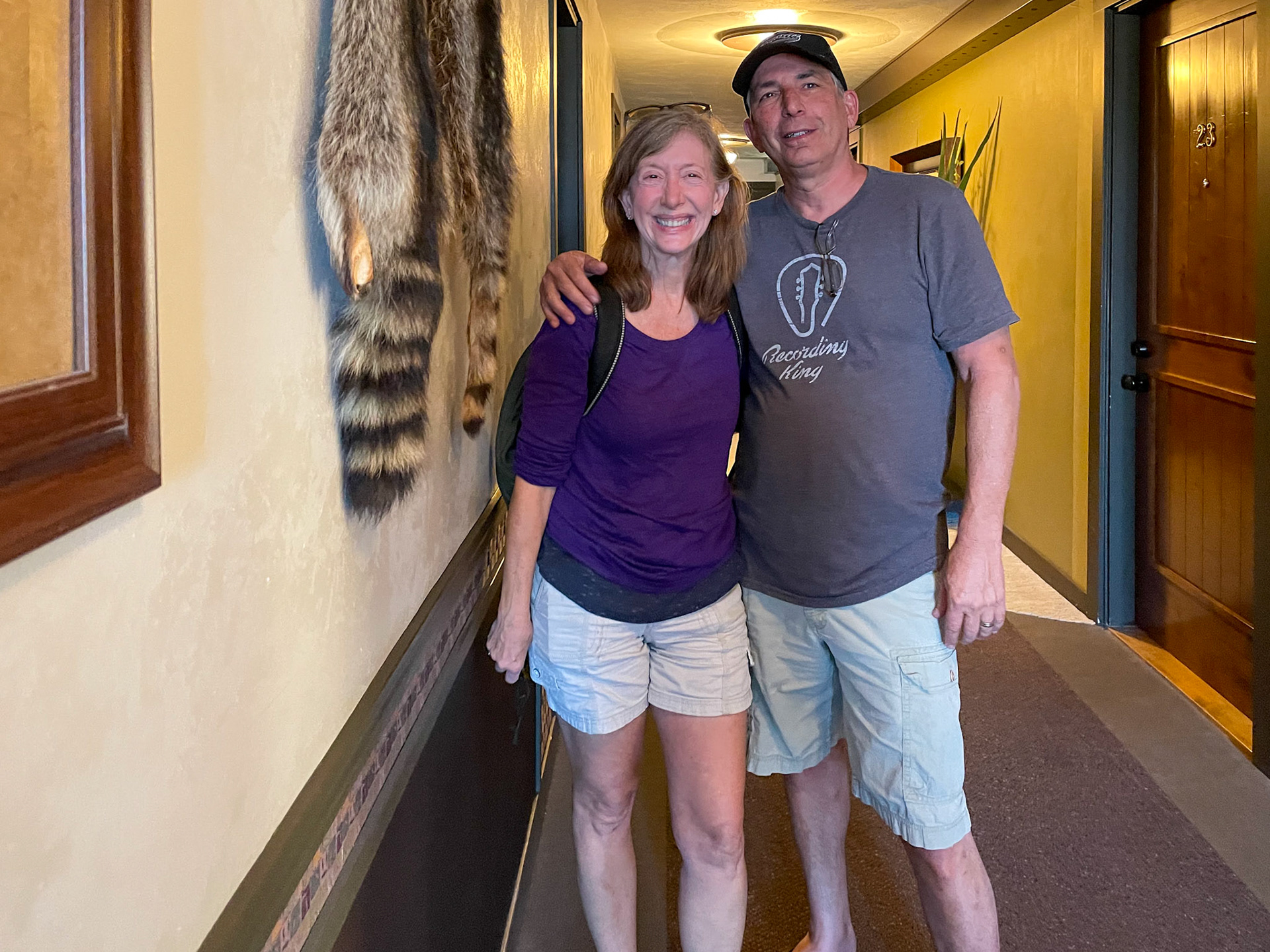 The hallway at Steve &amp; Tracey hotel room is decorated with old western style and racoon pelts