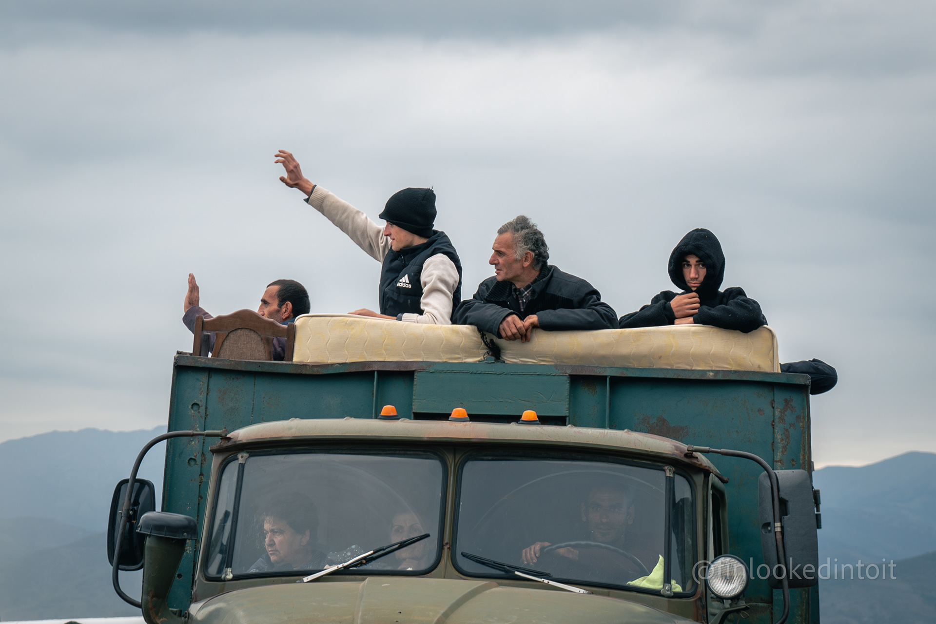 Armenians from Nagorno-Karabakh squeeze into a truck and cross the border into Armenia-proper after Azerbaijan ethnically cleansed the region, 09/26/2023