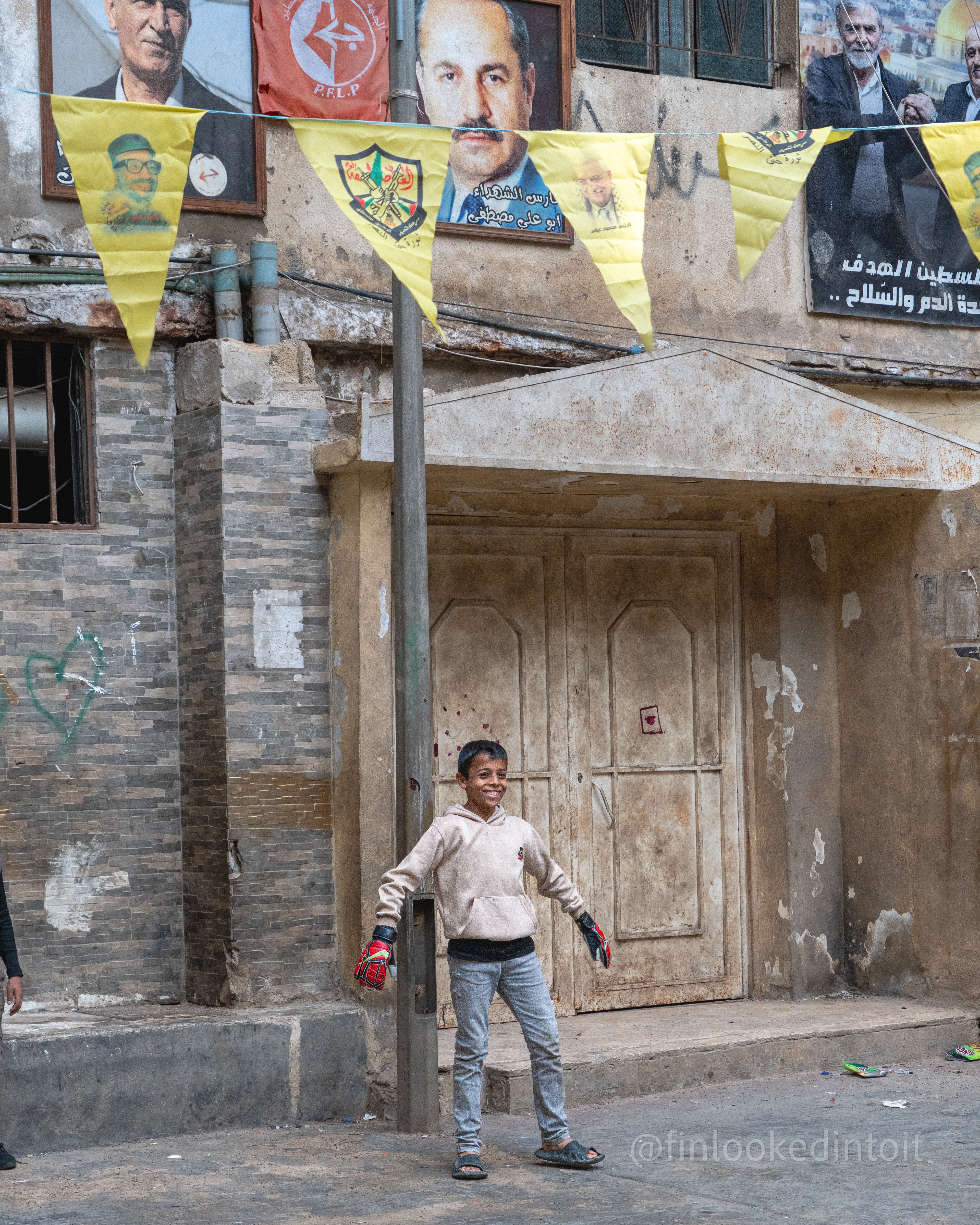 A Palestinian boy plays soccer in the doorway of a building in Beirut's Shatila refugee camp, 03/19/2024