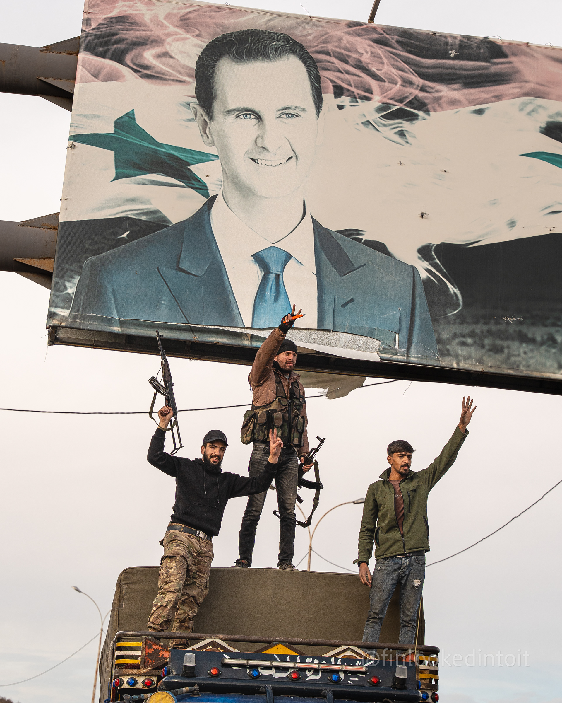 Syrian rebels tear down a banner of former dictator Bashar Al-Assad on the outskirts of Damascus, 12/11/2024