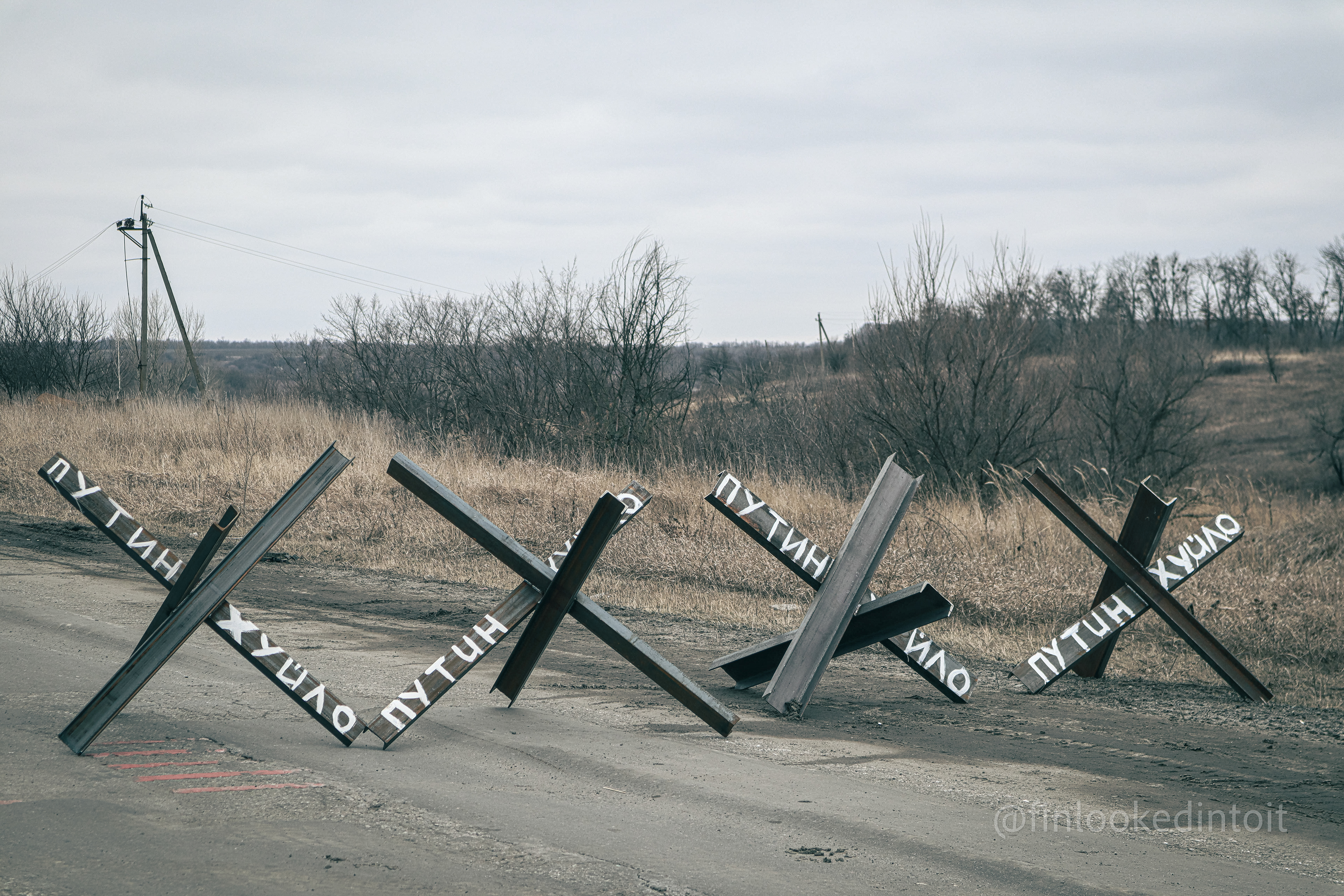 Hedgehog tank traps inscribed with the Russian words "Putin / Dickhead" in Kharkiv Oblast, 02/28/2022
